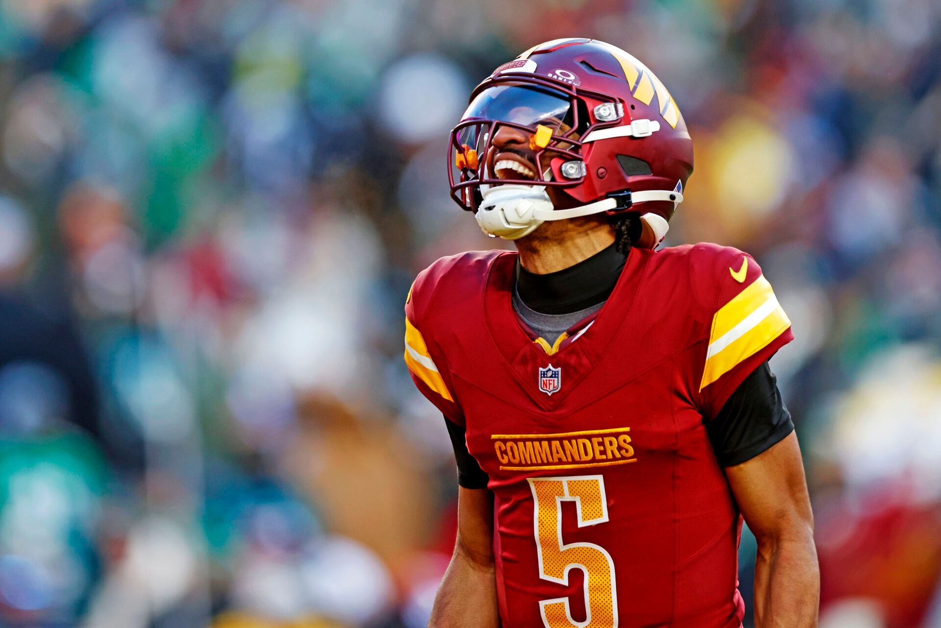 Dec 22, 2024; Landover, Maryland, USA; Washington Commanders quarterback Jayden Daniels (5) celebrates after throwing a touchdown during the fourth quarter against the Philadelphia Eagles at Northwest Stadium. Mandatory Credit: Peter Casey-Imagn Images