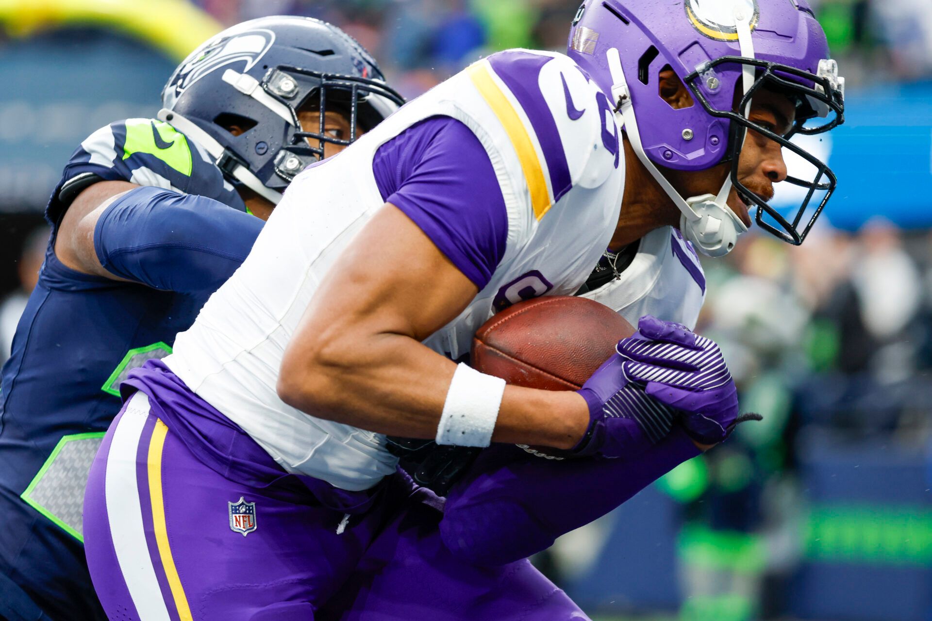 Dec 22, 2024; Seattle, Washington, USA; Minnesota Vikings wide receiver Justin Jefferson (18) catches a touchdown pass against Seattle Seahawks cornerback Tre Brown (22) during the second quarter at Lumen Field. Mandatory Credit: Joe Nicholson-Imagn Images