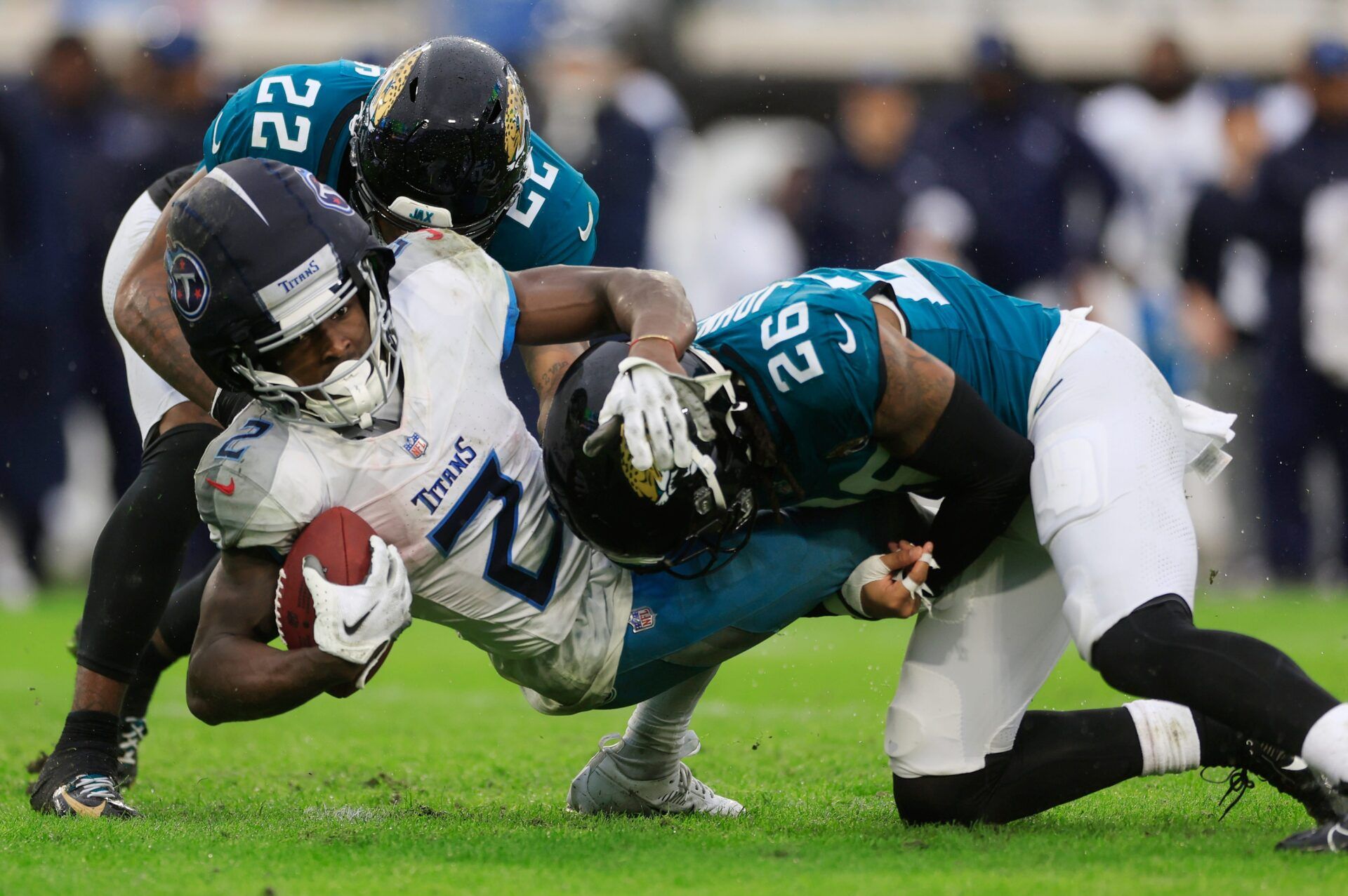 Jacksonville Jaguars cornerback Jarrian Jones (22) and safety Antonio Johnson (26) combine to tackle Tennessee Titans running back Tyjae Spears (2) during the second quarter of an NFL football matchup Sunday, Dec. 29, 2024 at EverBank Stadium in Jacksonville, Fla. [Corey Perrine/Florida Times-Union]