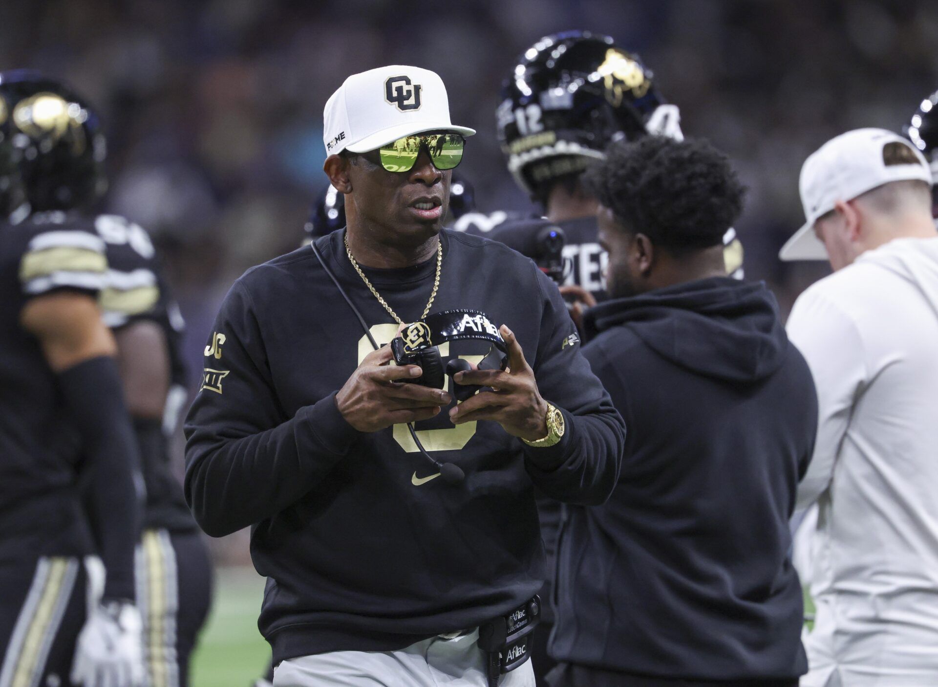 Colorado Buffaloes head coach Deion Sanders walks on the field between plays during the first quarter against the Brigham Young Cougars at Alamodome.