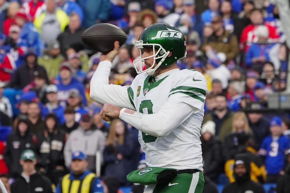 New York Jets quarterback Aaron Rodgers (8) throws the ball against the Buffalo Bills during the second half at Highmark Stadium.