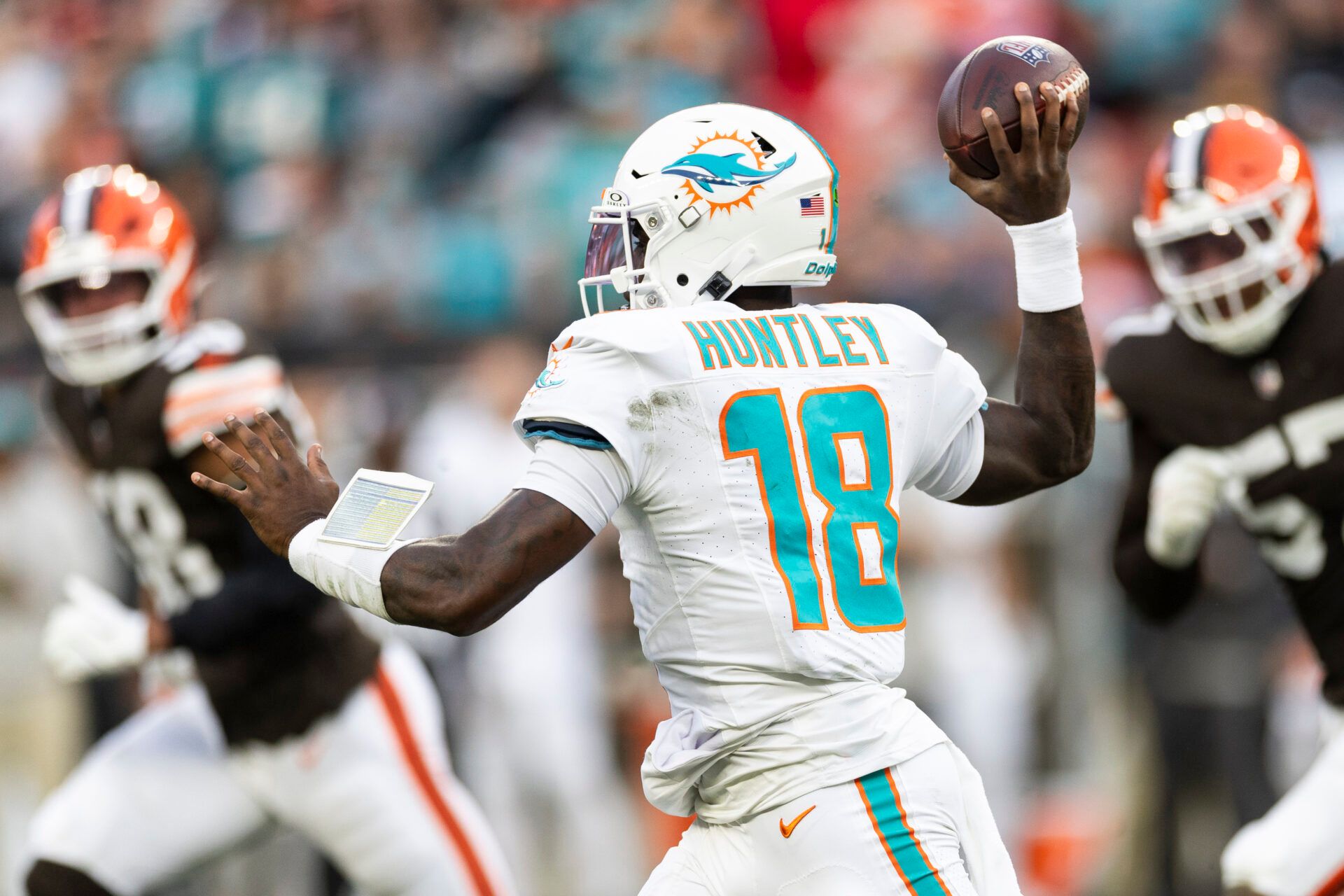 Dec 29, 2024; Cleveland, Ohio, USA; Miami Dolphins quarterback Tyler Huntley (18) throws the ball against the Cleveland Browns during the first quarter at Huntington Bank Field. Mandatory Credit: Scott Galvin-Imagn Images