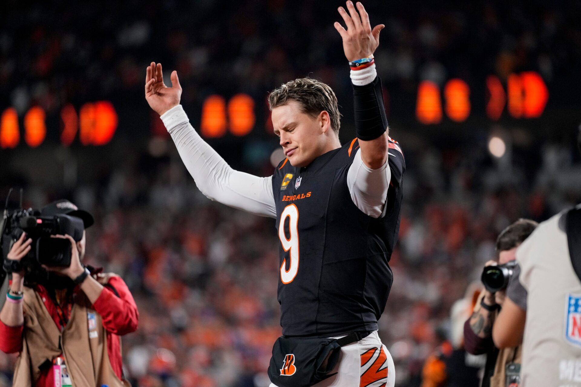 Bengals quarterback Joe Burrow (9) celebrates after the game-winning touchdown pass to Tee Higgins in overtime of the NFL Week 17 game between the Cincinnati Bengals and the Denver Broncos at Paycor Stadium in downtown Cincinnati on Saturday, Dec. 28, 2024. The Bengals took a 30-24 win in overtime to remain in the post season chase.