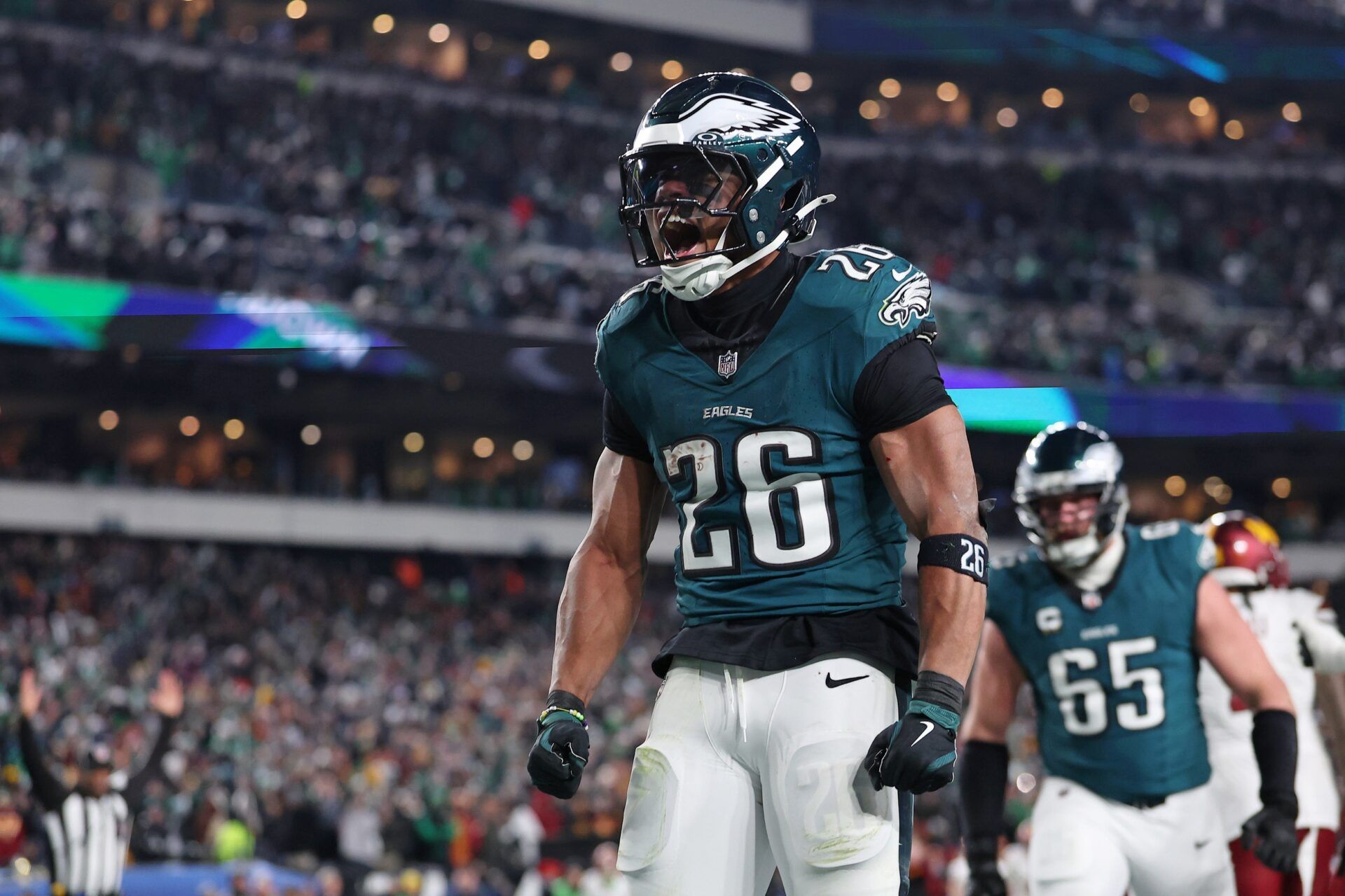 Philadelphia Eagles running back Saquon Barkley (26) celebrates after a touchdown against the Washington Commanders during the second half in the NFC Championship game at Lincoln Financial Field.