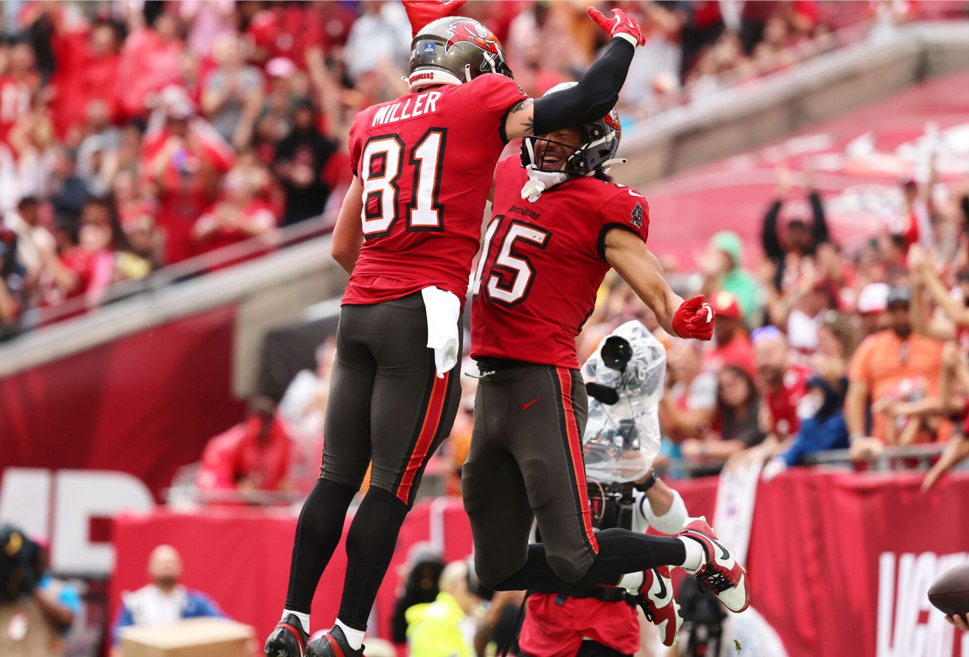 Dec 29, 2024; Tampa, Florida, USA; Tampa Bay Buccaneers wide receiver Jalen McMillan (15) is congratulated by wide receiver Ryan Miller (81) after he scored a touchdown against the Carolina Panthers during the second half at Raymond James Stadium. Mandatory Credit: Kim Klement Neitzel-Imagn Images