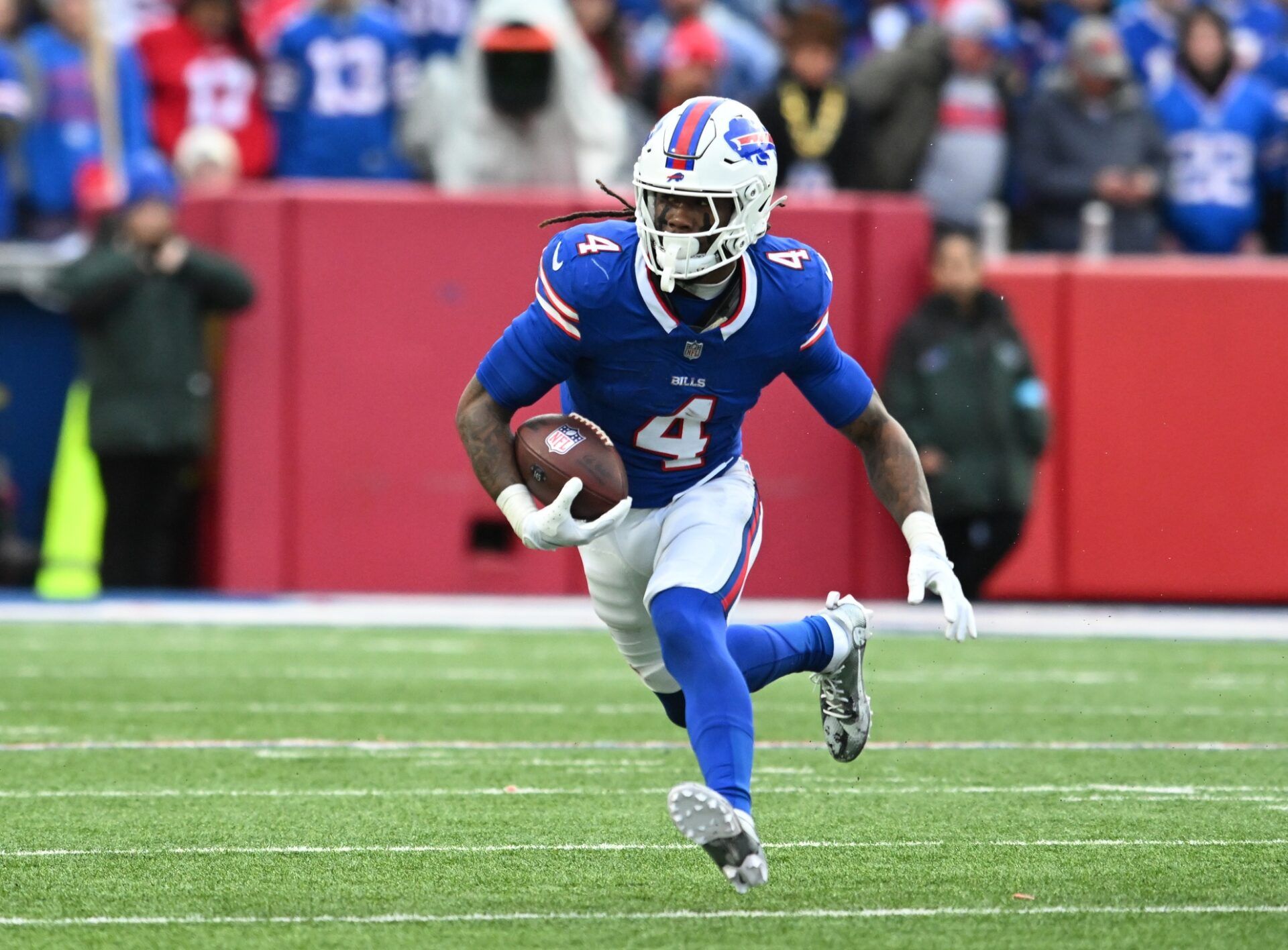 Buffalo Bills running back James Cook (4) runs with the ball against the New York Jets in the second quarter at Highmark Stadium.