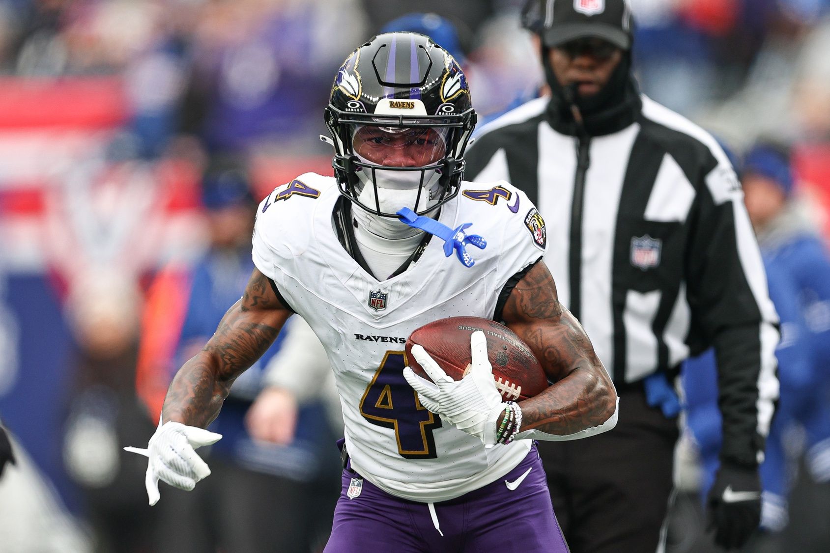 Baltimore Ravens wide receiver Zay Flowers (4) carries the ball against the New York Giants during the first quarter at MetLife Stadium.