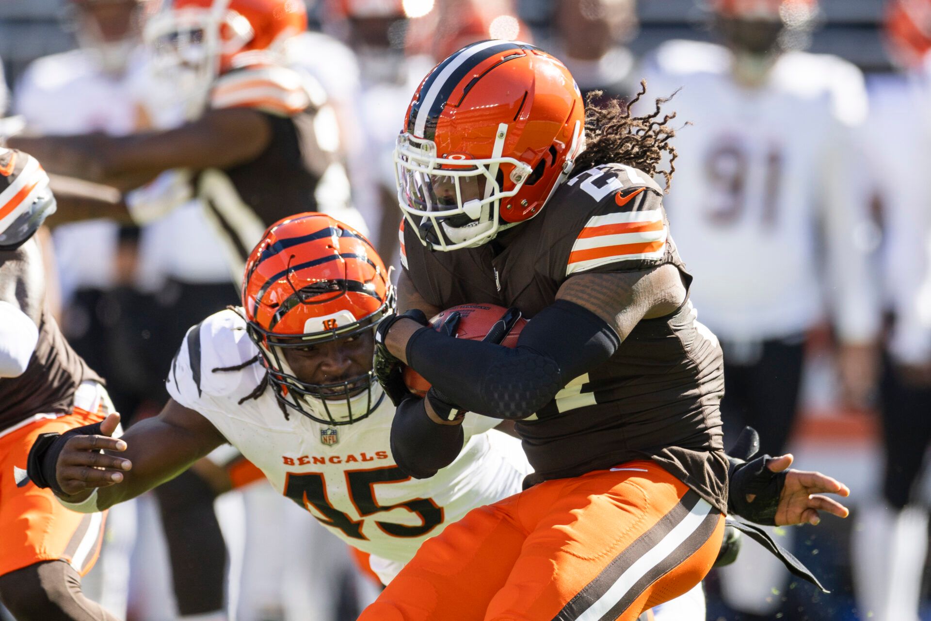 Oct 20, 2024; Cleveland, Ohio, USA; Cleveland Browns running back D'Onta Foreman (27) is tackled by Cincinnati Bengals linebacker Maema Njongmeta (45) as he returns the kickoff during the first quarter at Huntington Bank Field. Mandatory Credit: Scott Galvin-Imagn Images