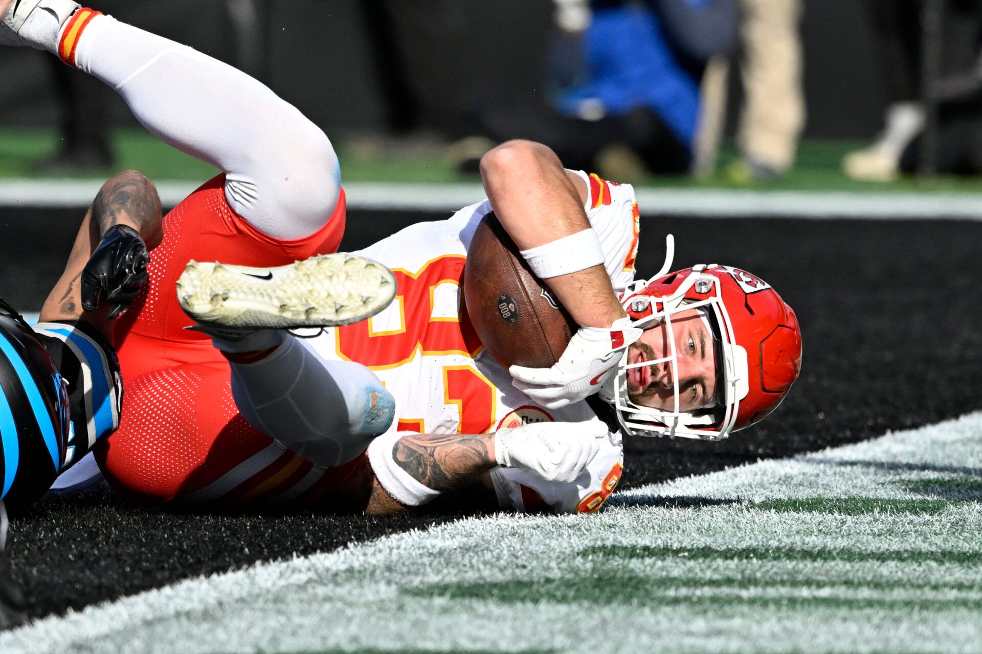 Nov 24, 2024; Charlotte, North Carolina, USA; Kansas City Chiefs tight end Noah Gray (83) scores a touchdown as Carolina Panthers cornerback Dane Jackson (23) defends in the second quarter at Bank of America Stadium. Mandatory Credit: Bob Donnan-Imagn Images