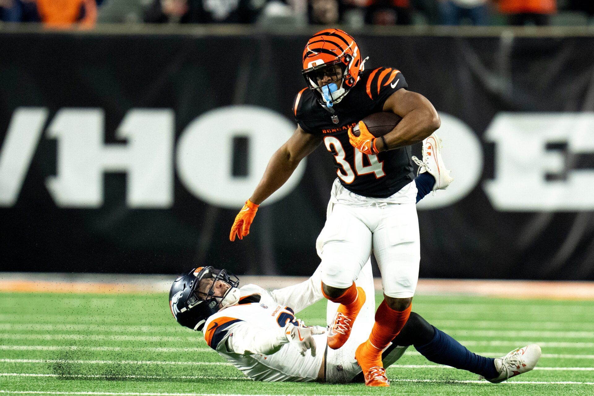 Denver Broncos cornerback Riley Moss (21) tackles Cincinnati Bengals halfback Khalil Herbert (34) in the overtime of the NFL game at Paycor Stadium in Cincinnati on Saturday, Dec. 28, 2024.