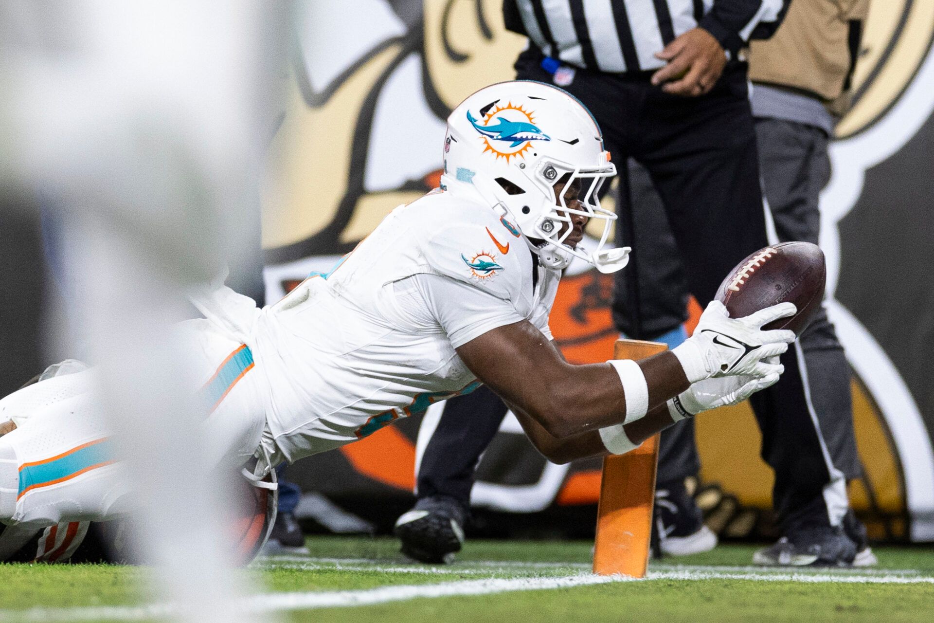 Dec 29, 2024; Cleveland, Ohio, USA; Miami Dolphins tight end Jonnu Smith (9) dives into the end zone for a touchdown during the fourth quarter against the Cleveland Browns at Huntington Bank Field. Mandatory Credit: Scott Galvin-Imagn Images