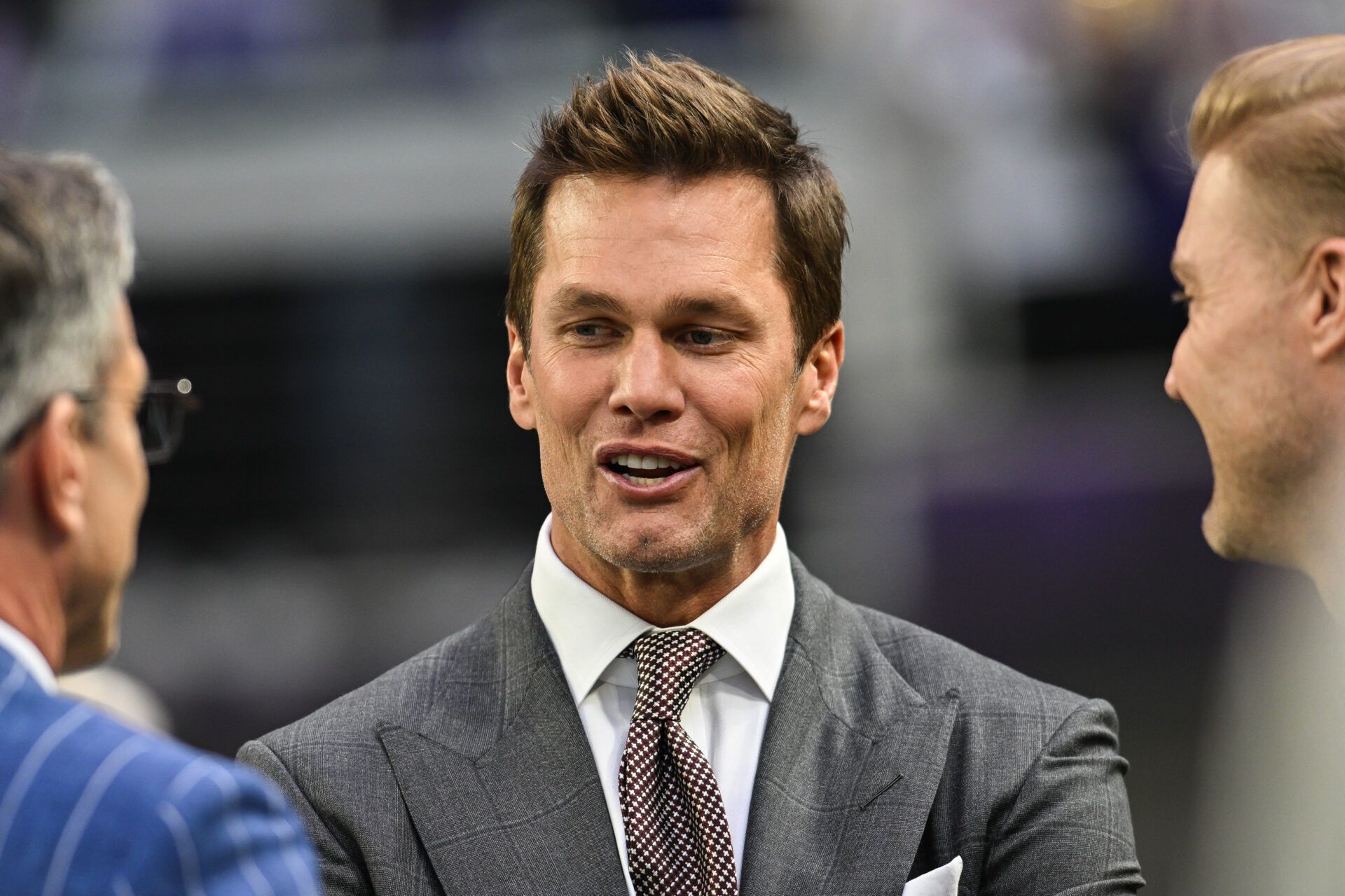 Dec 29, 2024; Minneapolis, Minnesota, USA; FOX broadcaster and former NFL quarterback Tom Brady looks on before the game between the Minnesota Vikings and the Green Bay Packers at U.S. Bank Stadium. Mandatory Credit: Jeffrey Becker-Imagn Images