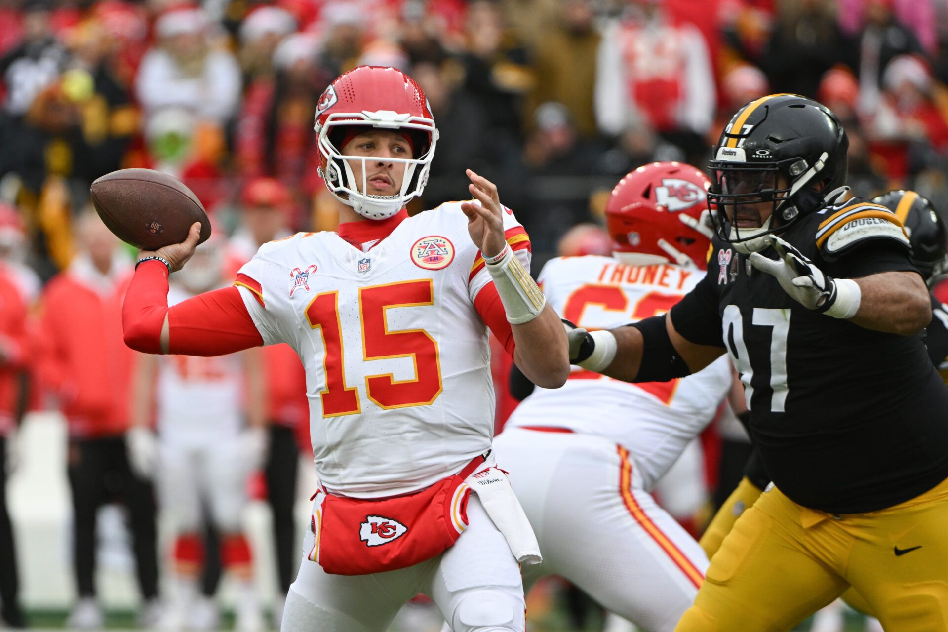 Dec 25, 2024; Pittsburgh, Pennsylvania, USA; Kansas City Chiefs quarterback Patrick Mahomes (15) throws a pass while being pressured by Pittsburgh Steelers defensive tackle Cameron Heyward (97) during the first quarter at Acrisure Stadium. Mandatory Credit: Barry Reeger-Imagn Images