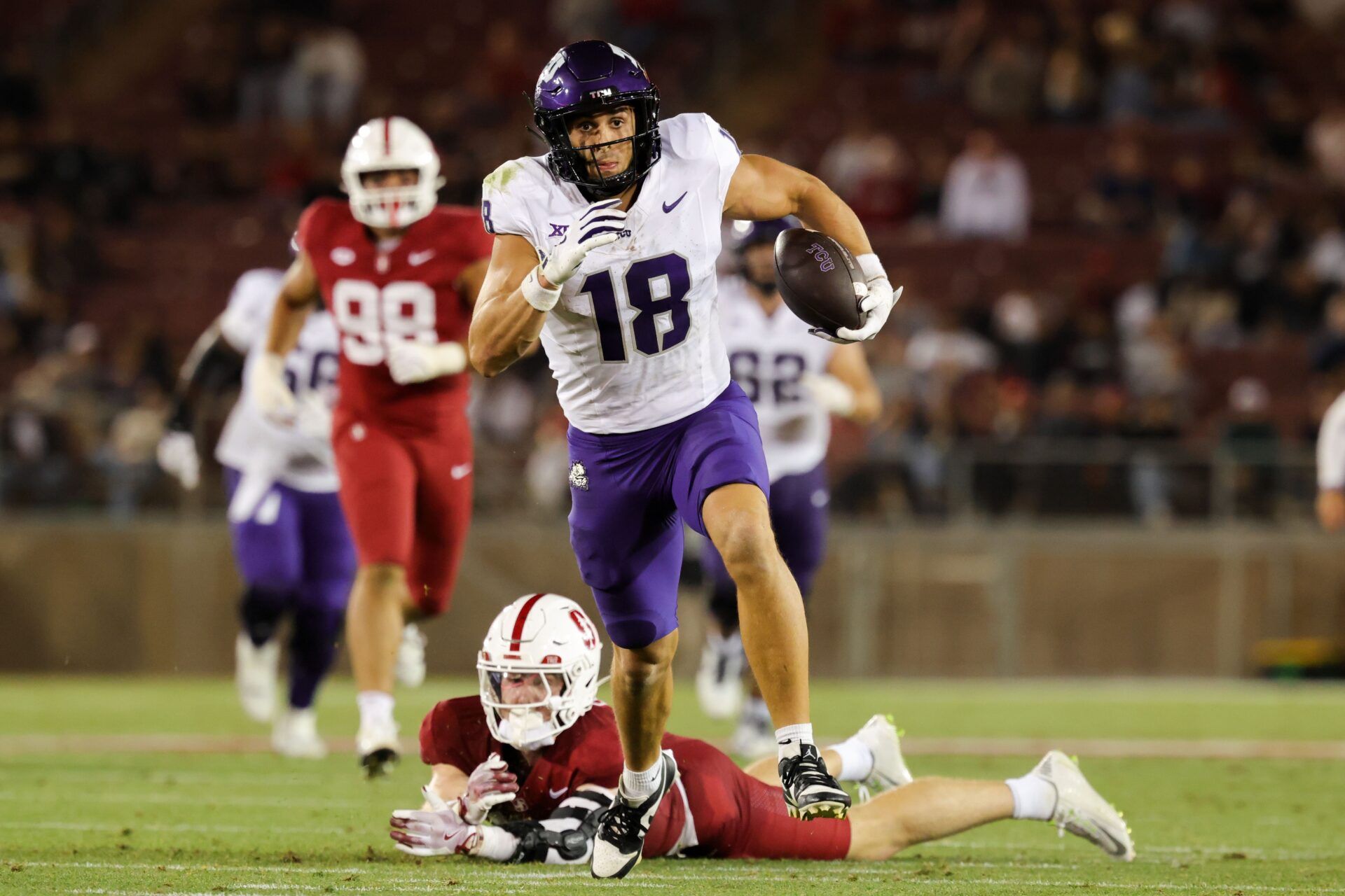 TCU Horned Frogs wide receiver Jack Bech (18) runs with the ball past Stanford Cardinal safety Scotty Edwards (21) during the second half at Stanford Stadium.