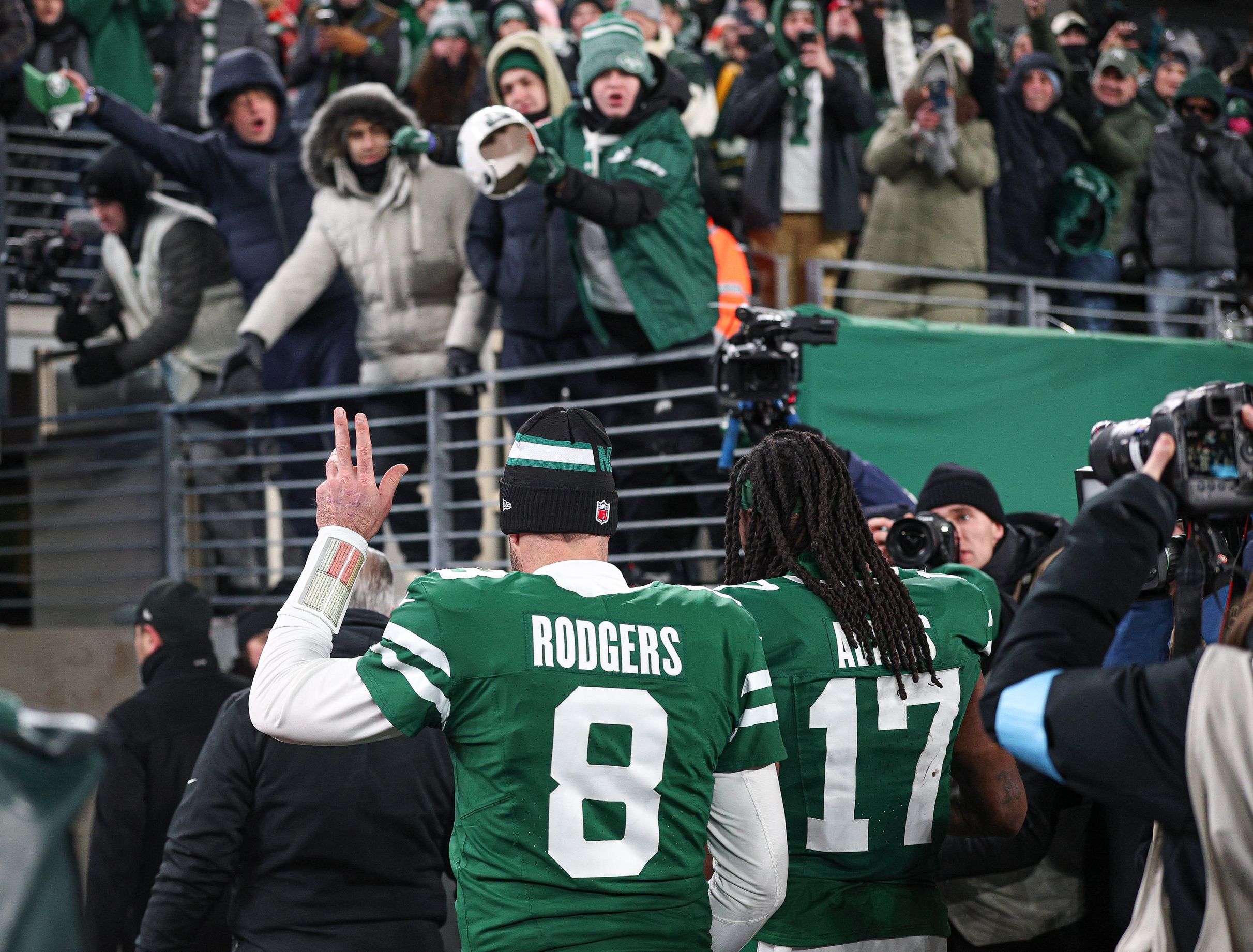 New York Jets quarterback Aaron Rodgers (8) walks off the field with wide receiver Davante Adams (17) after the game against the Miami Dolphins at MetLife Stadium.