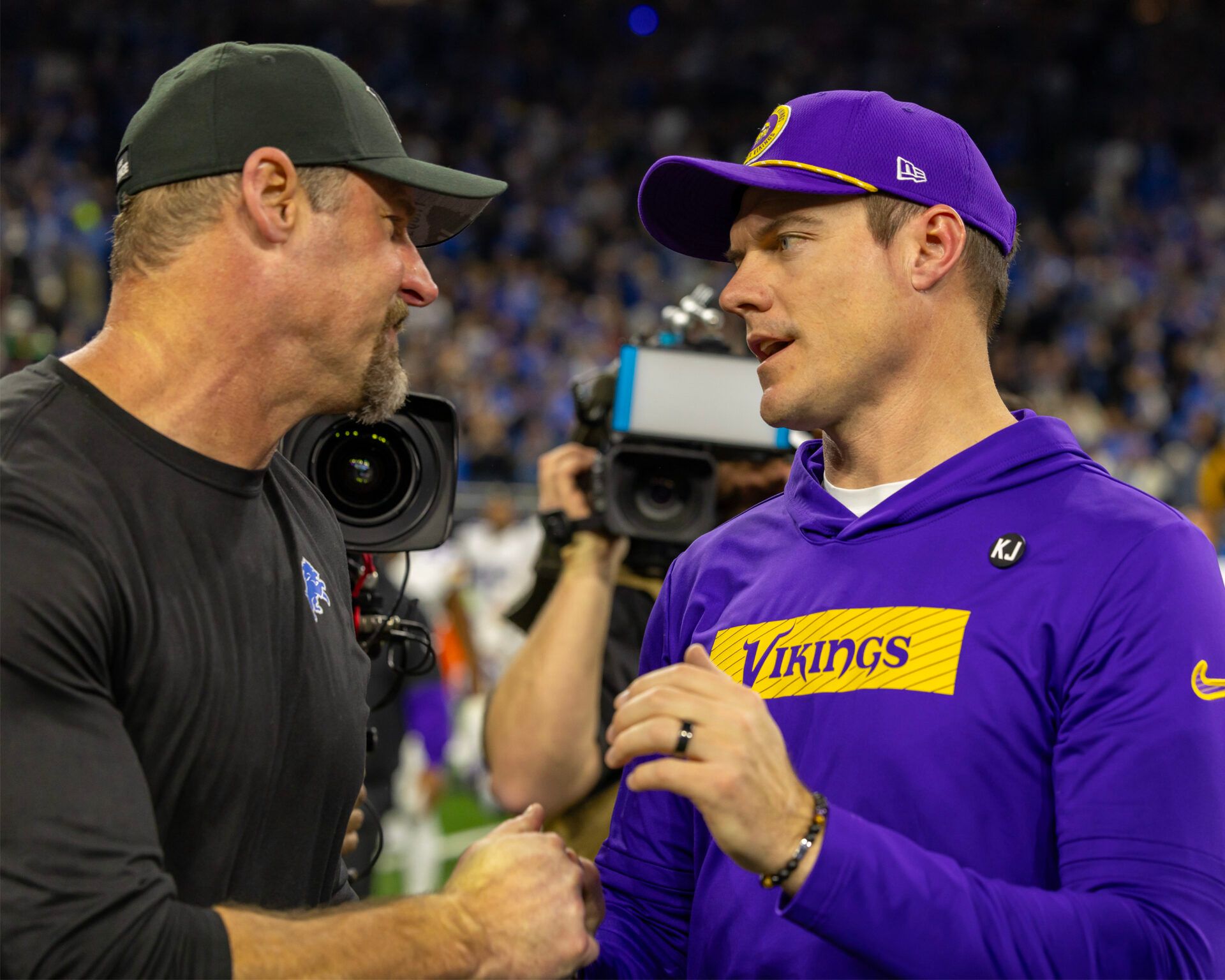 Jan 5, 2025; Detroit, Michigan, USA; Detroit Lions Head Coach Dan Campbell (L) shakes hands with Minnesota Vikings Head Coach Sean McDermott after the game at Ford Field. Mandatory Credit: David Reginek-Imagn Images