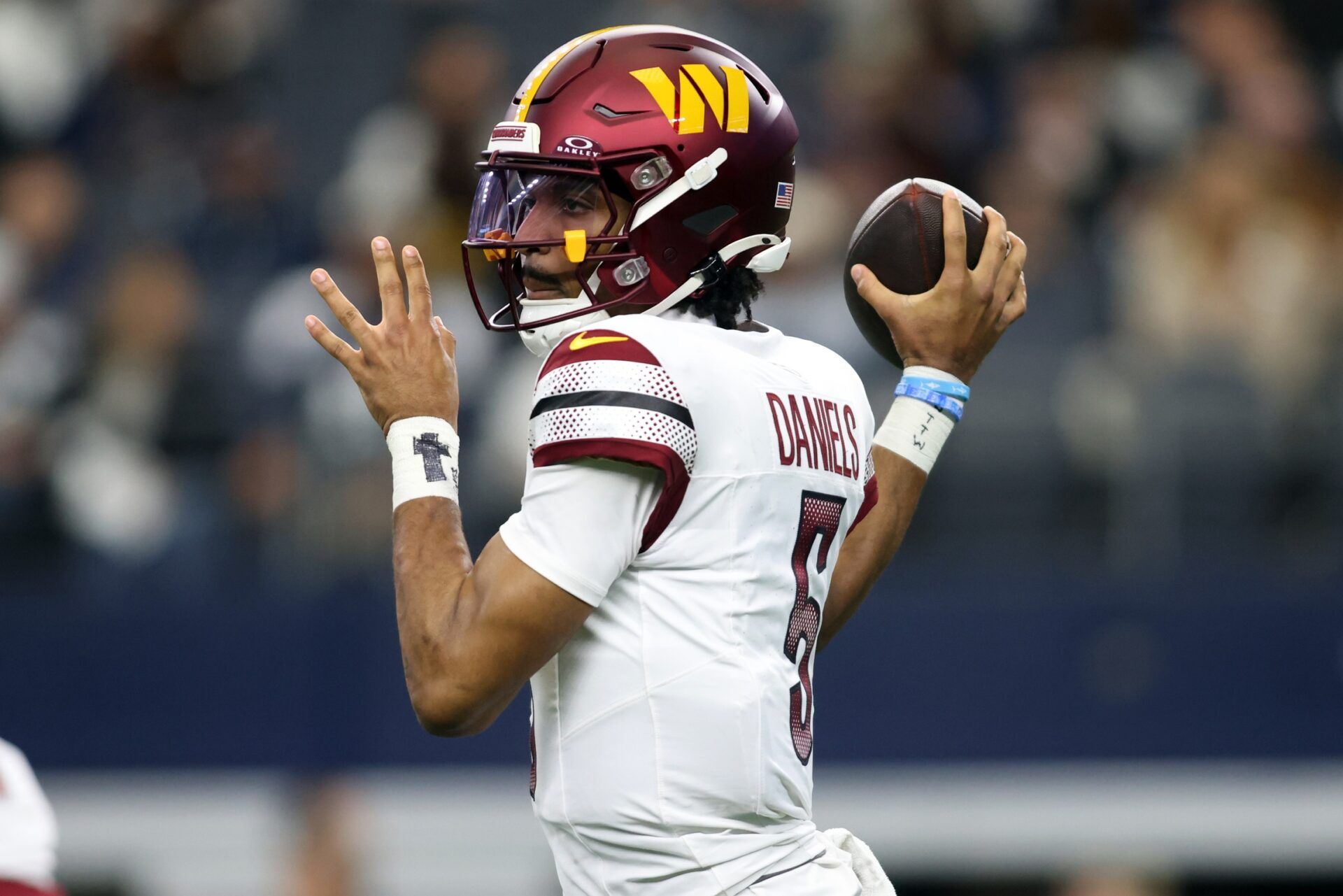 Washington Commanders quarterback Jayden Daniels (5) throws a pass against the Dallas Cowboys during the first quarter at AT&T Stadium.