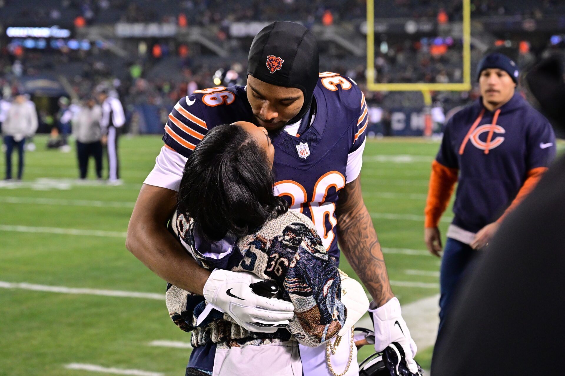 United States gymnast Simone Biles greets husband and Chicago Bears defensive back Jonathan Owens (36) before the game against the Seattle Seahawks at Soldier Field.