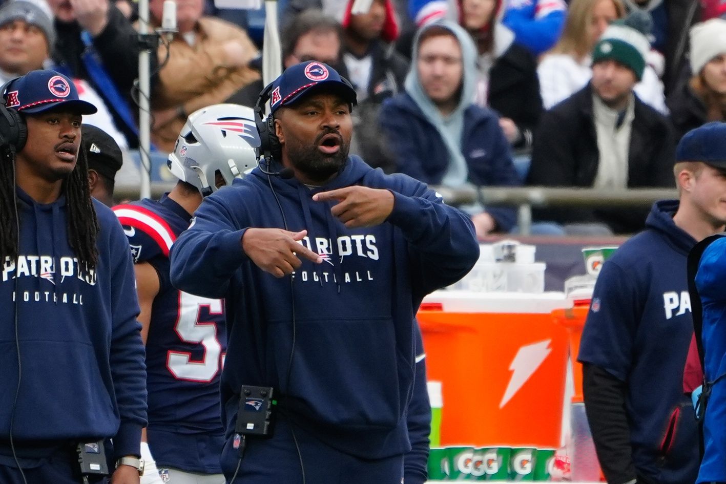 New England Patriots heac coach Jerod Mayo speaks and motions to his players on the field during the first half against the Los Angeles Chargers at Gillette Stadium.