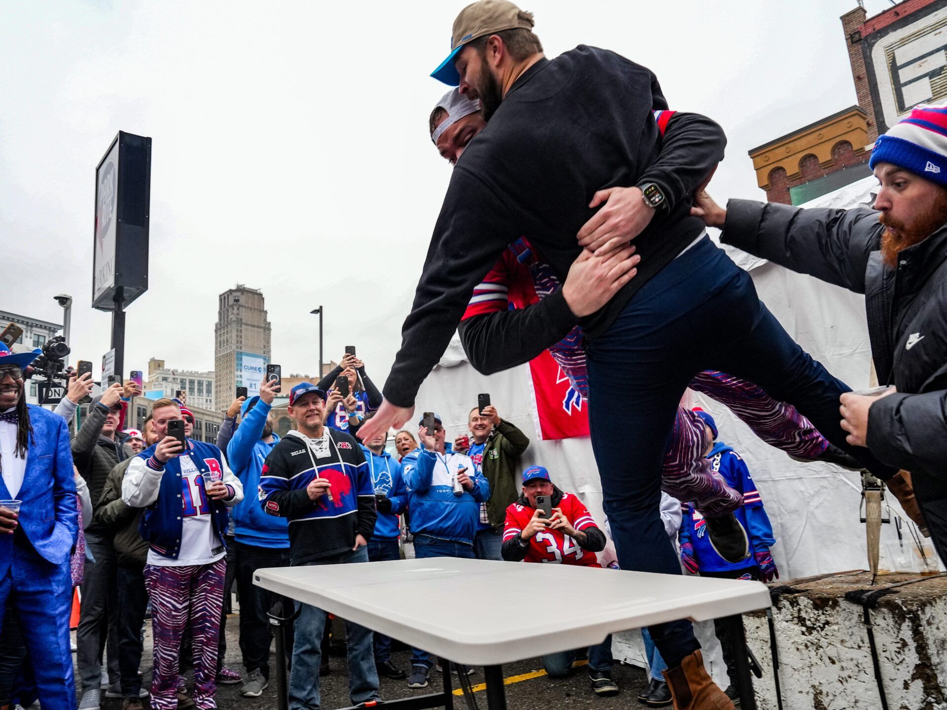 The Buffalo Bills do not allow table slamming in stadium parking lots, but the policy does not stop Bills Mafia from jumping on tables to celebrate.