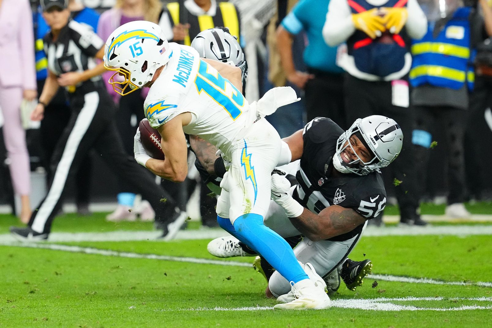 Las Vegas Raiders linebacker Amari Burney (56) attempts to tackle Los Angeles Chargers wide receiver Ladd McConkey (15) during the first quarter at Allegiant Stadium.