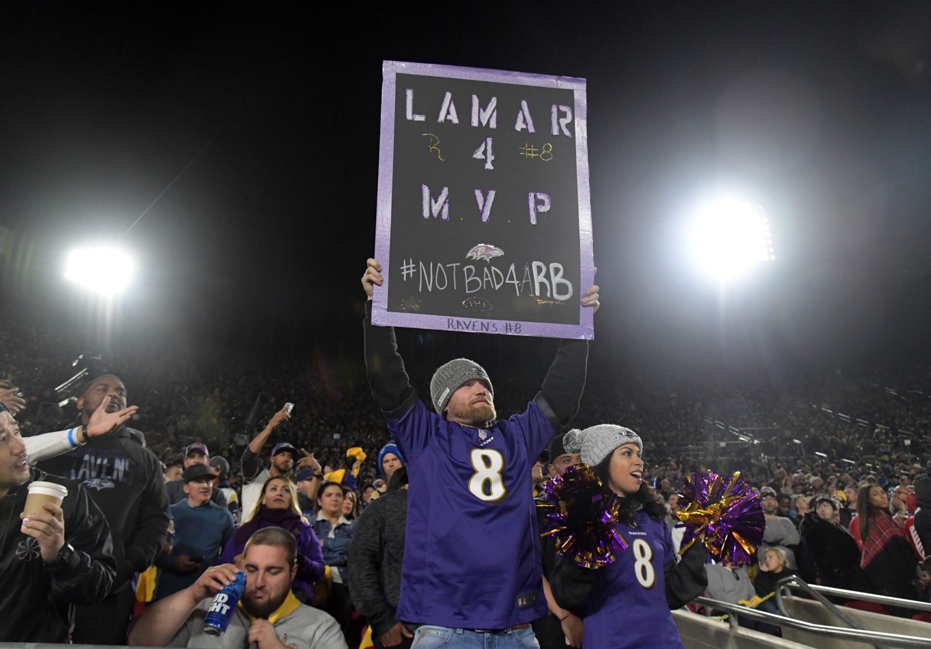 A fan of Baltimore Ravens quarterback Lamar Jackson (8) holds a sign that reads 