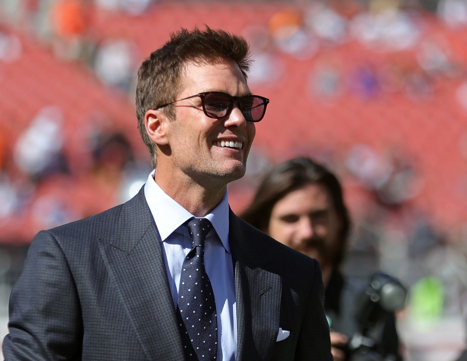 NFL legend Tom Brady is all smiles before an NFL football game at Huntington Bank Field, Sunday, Sept. 8, 2024, in Cleveland, Ohio.