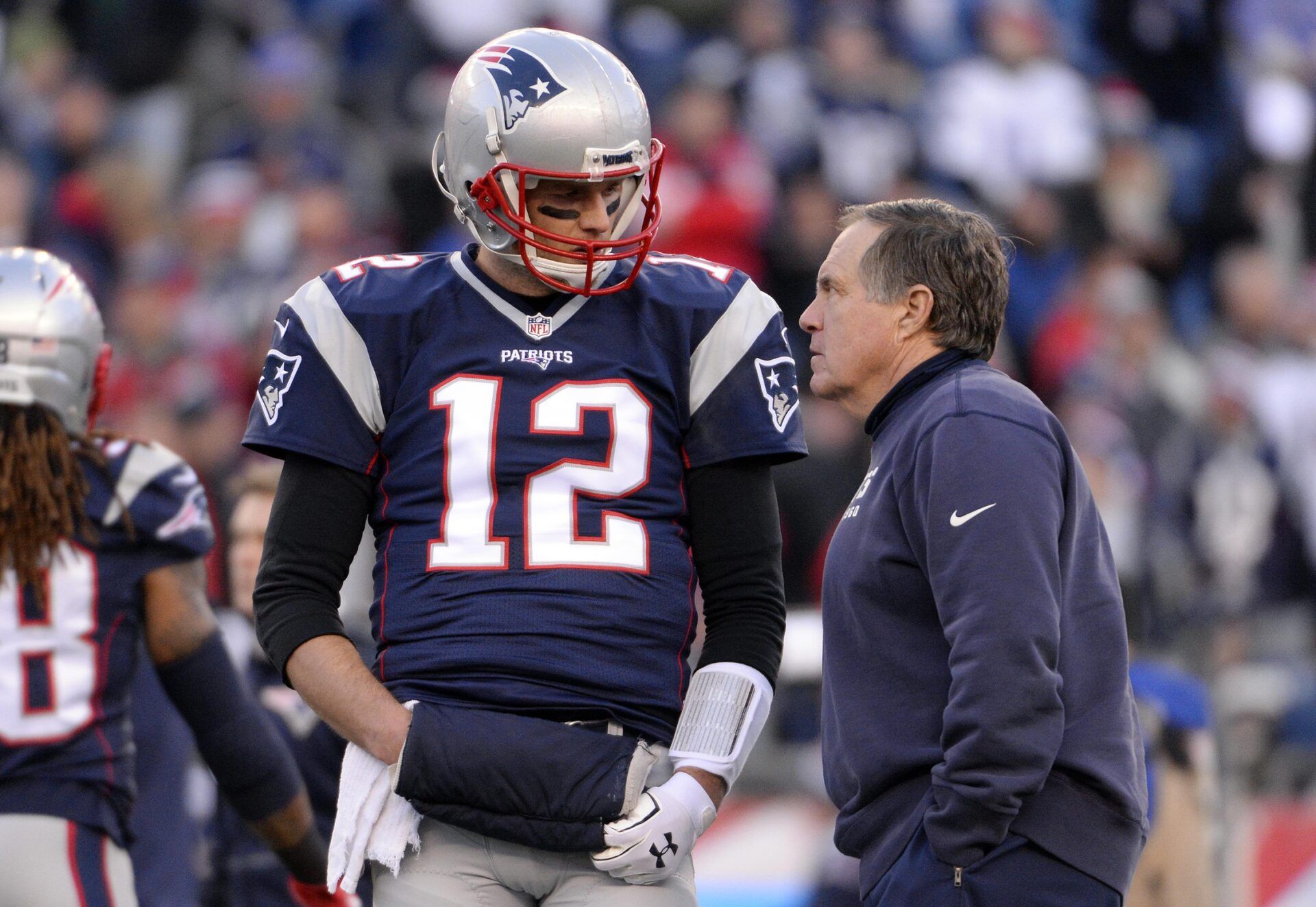 New England Patriots quarterback Tom Brady (12) talks with New England Patriots head coach Bill Belichick before the game against the Kansas City Chiefs in the AFC Divisional round playoff game at Gillette Stadium.