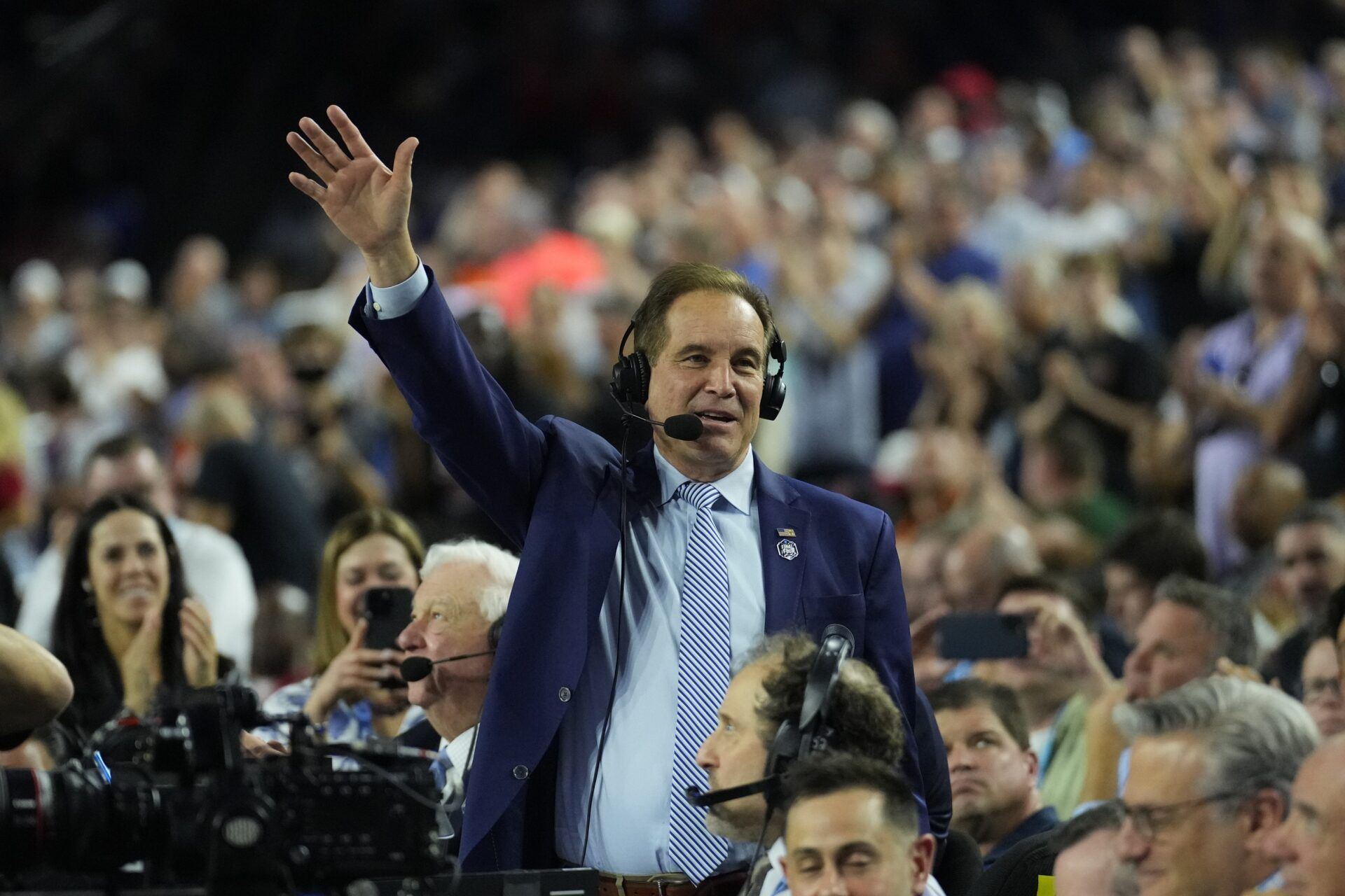 CBS broadcaster Jim Nantz acknowledges the crowd in the semifinals of the Final Four of the 2023 NCAA Tournament between the Florida Atlantic Owls and San Diego State Aztecs at NRG Stadium.