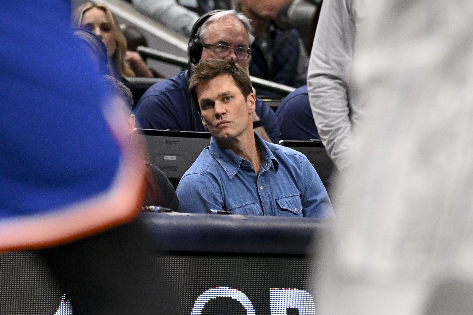 Former NFL quarterback Tom Brady watches the game between the Dallas Mavericks and the New York Knicks during the second quarter at the American Airlines Center.