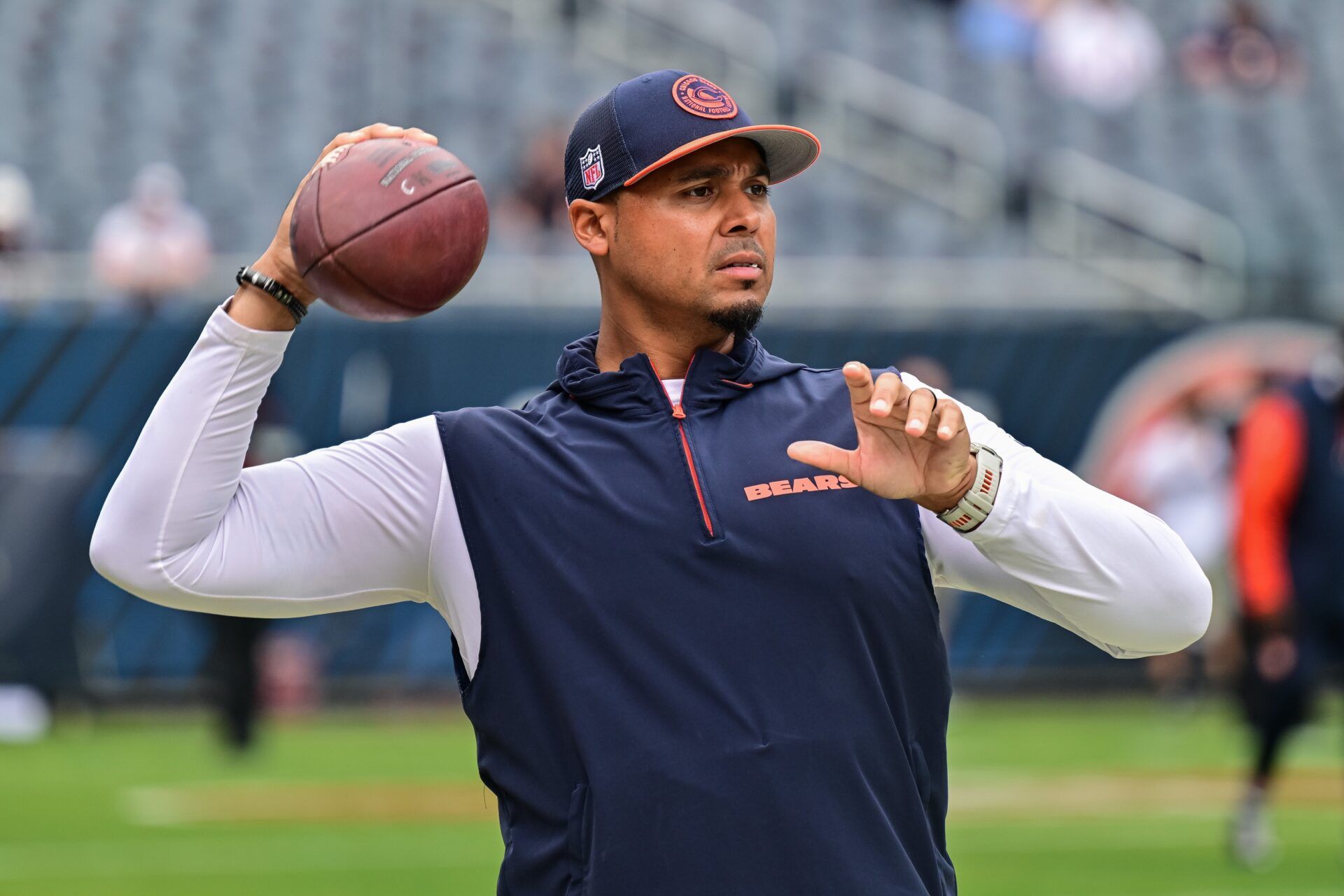 Chicago Bears general manager Ryan Poles plays catch on the sideline before the game against the Cincinnati Bengals at Soldier Field.