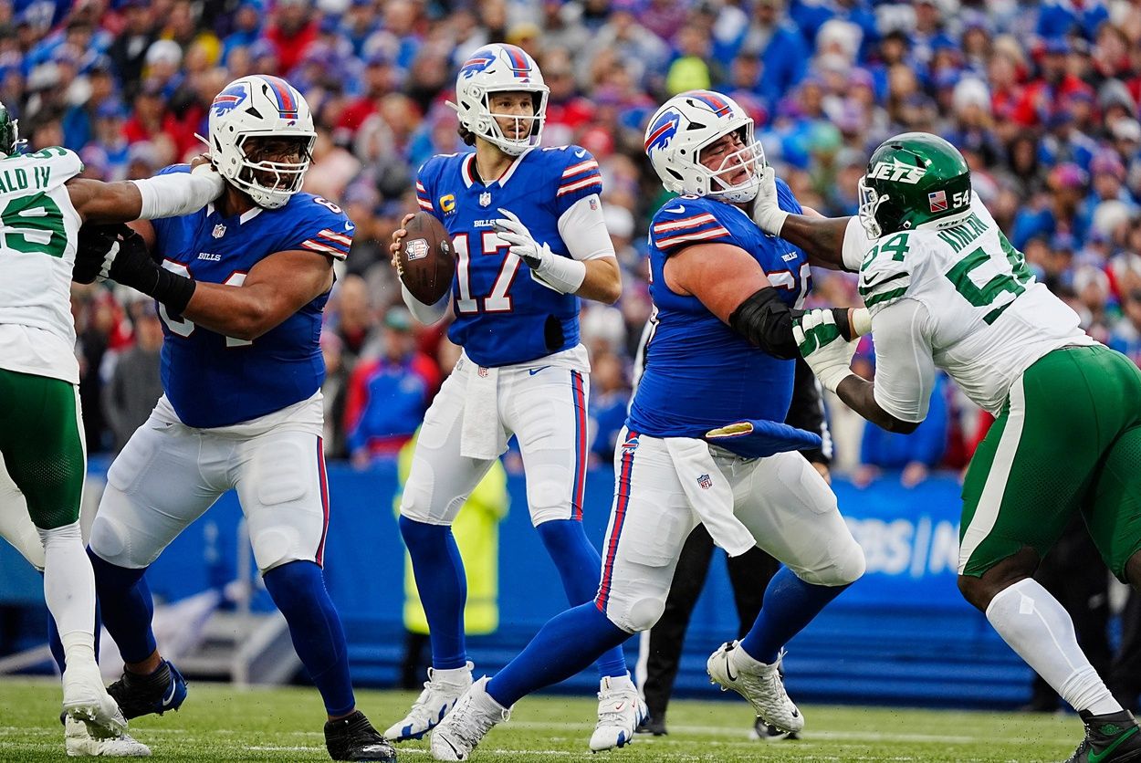 Buffalo Bills quarterback Josh Allen (17) gets pass protection from Buffalo Bills guard O'Cyrus Torrence (64) and Buffalo Bills guard Connor McGovern (66) during first half action at the Bills home game against the New York Jets at Highmark Stadium in Orchard Park on Dec. 29, 2024.