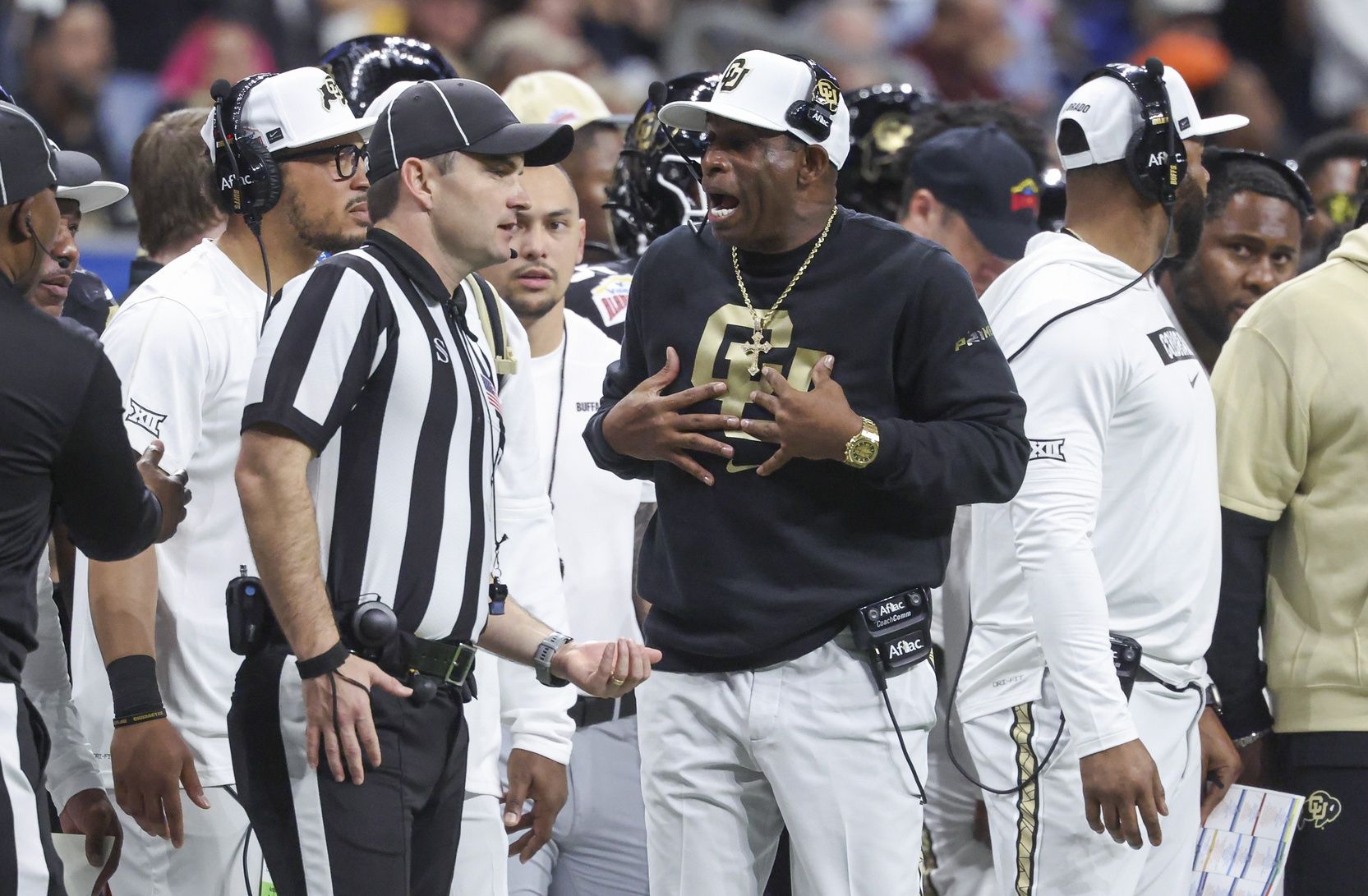 Colorado Buffaloes head coach Deion Sanders reacts with an official after a play during the second quarter against the Brigham Young Cougars at Alamodome.