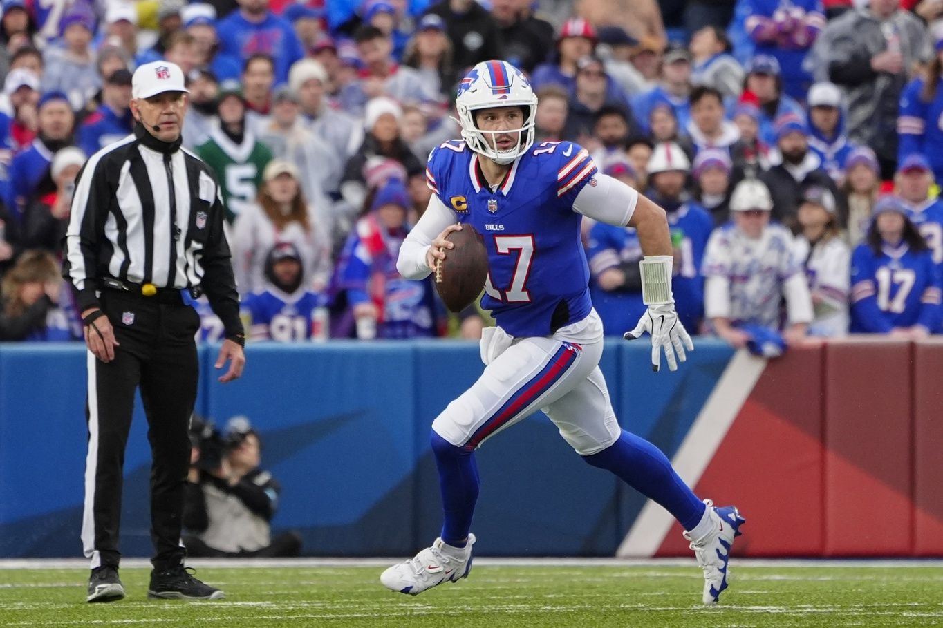 Buffalo Bills quarterback Josh Allen (17) rolls out looking to throw the ball against the New York Jets during the first half at Highmark Stadium.