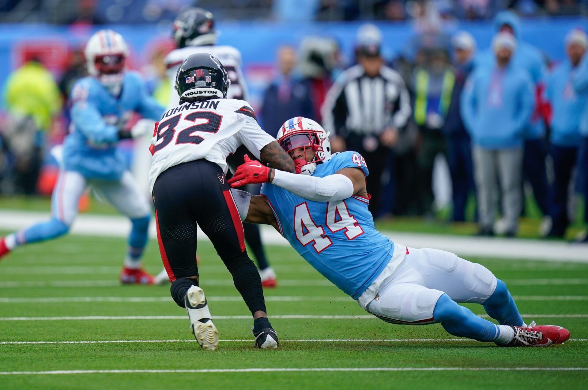 Tennessee Titans safety Mike Brown (44) tackles Houston Texans wide receiver Diontae Johnson (82) during the first quarter at Nissan Stadium in Nashville, Tenn., Sunday, Jan. 5, 2025.