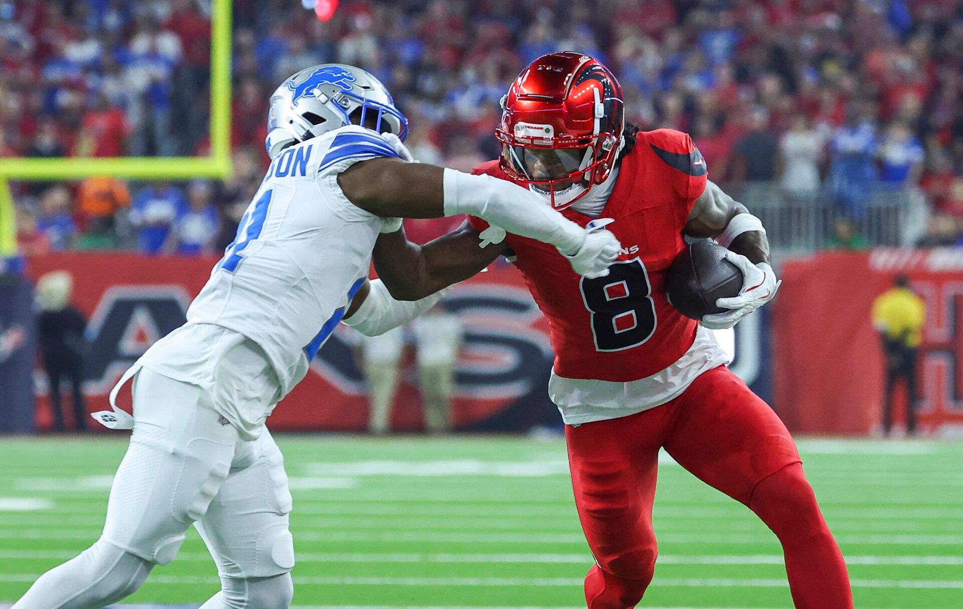 Nov 10, 2024; Houston, Texas, USA; Houston Texans wide receiver John Metchie III (8) makes a reception as Detroit Lions cornerback Amik Robertson (21) defends during the first quarter at NRG Stadium. Mandatory Credit: Troy Taormina-Imagn Images