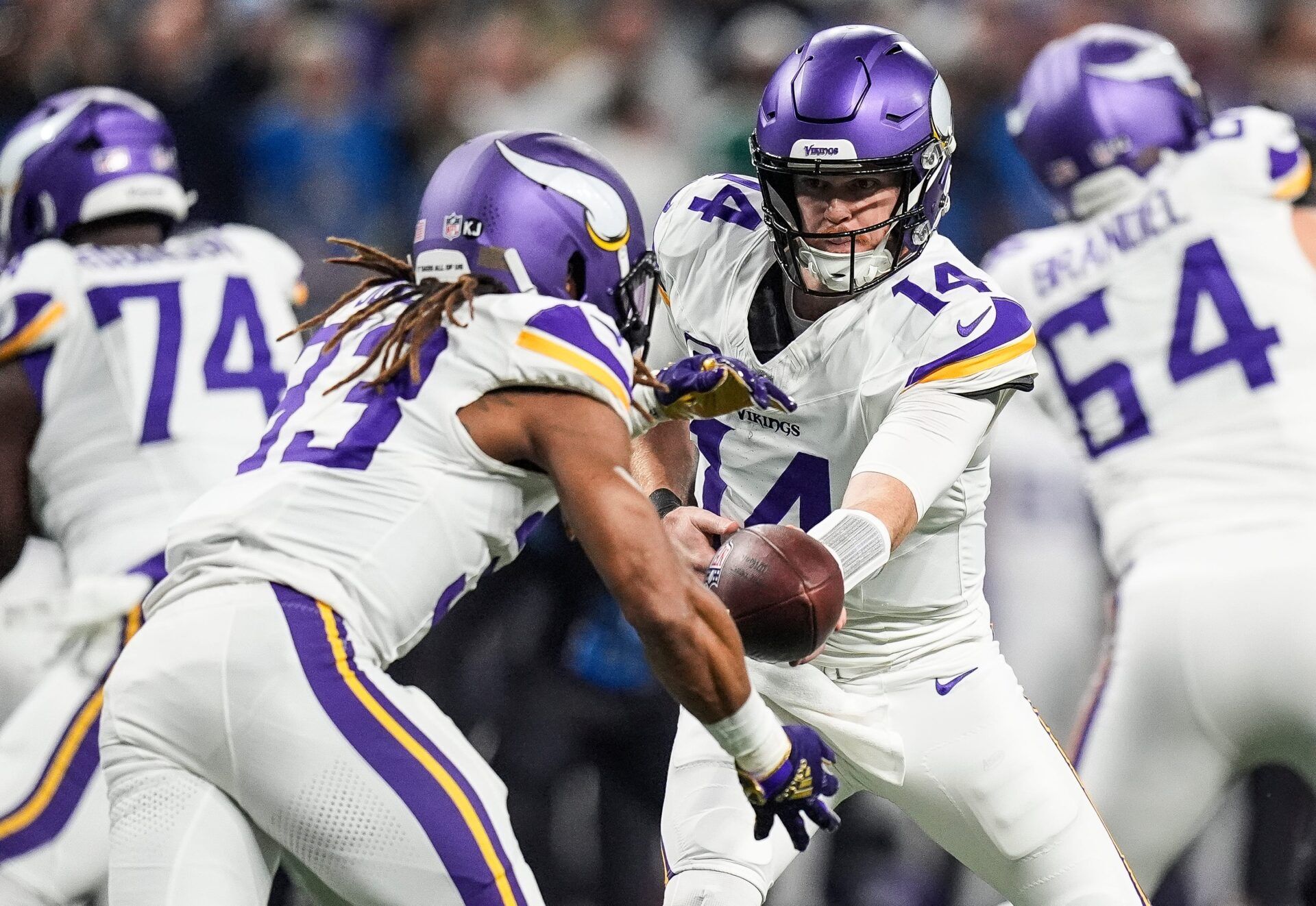 Minnesota Vikings quarterback Sam Darnold (14) hands the ball running back Aaron Jones (33) during the first half at Ford Field in Detroit on Sunday, Jan. 5, 2025.