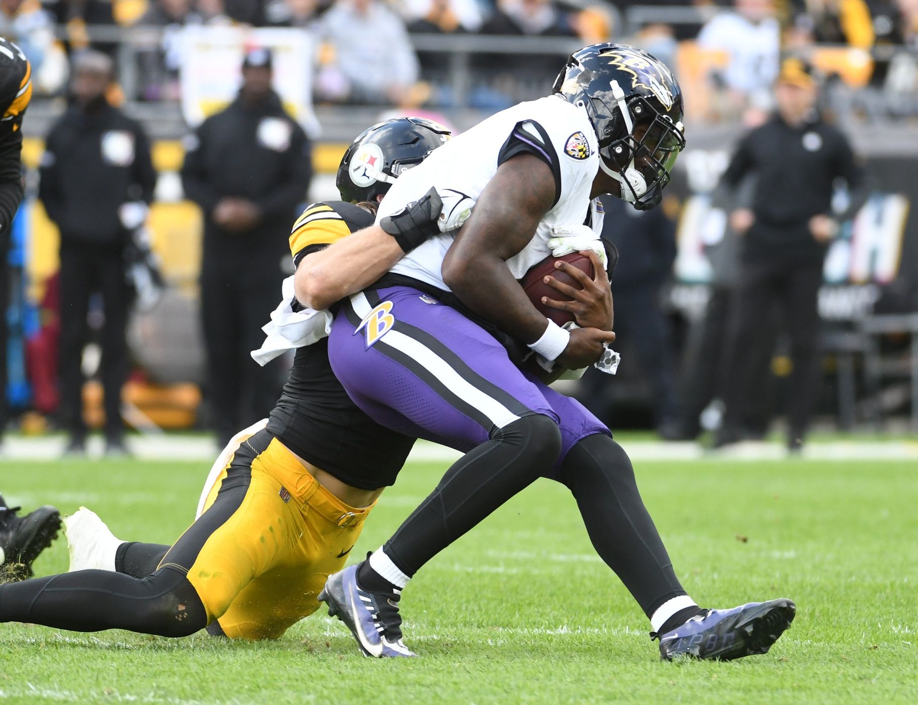 Baltimore Ravens quarterback Lamar Jackson (8) is stopped by Pittsburgh Steelers linebacker Cole Holcomb (55) during the second quarter at Acrisure Stadium.