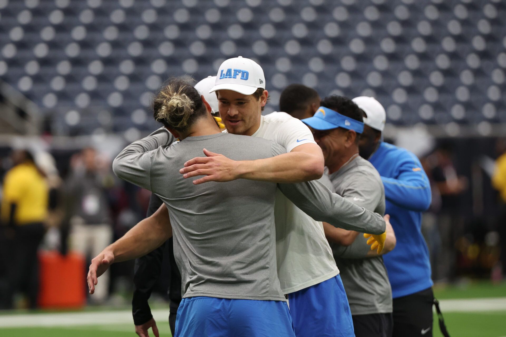 Jan 11, 2025; Houston, Texas, USA; Los Angeles Chargers quarterback Justin Herbert (10) hugs a teammate before playing against the Houston Texans in an AFC wild card game at NRG Stadium. Mandatory Credit: Thomas Shea-Imagn Images