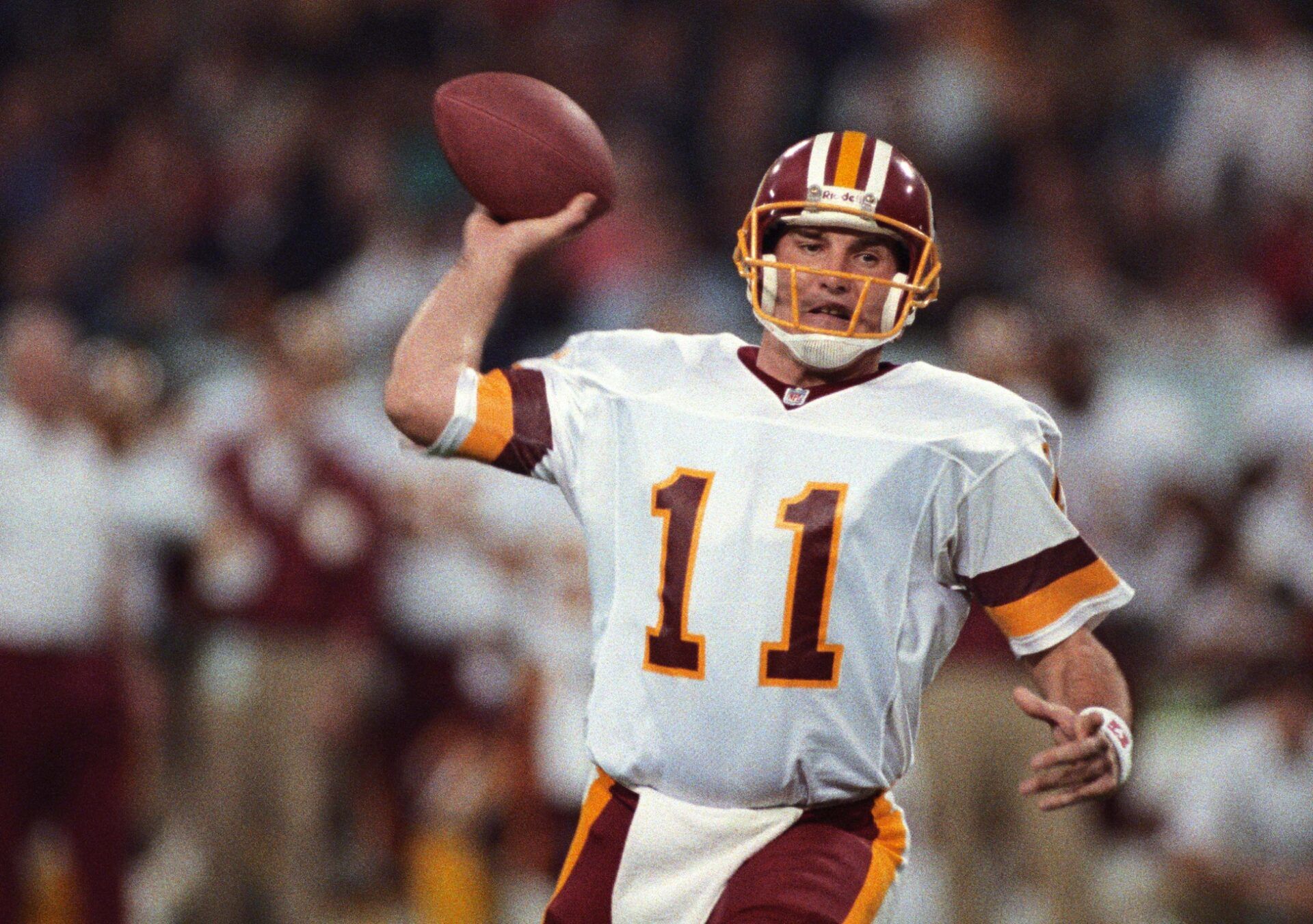 Washington Redskins quarterback Mark Rypien (11) looks to throw against the Buffalo Bills during Super Bowl XXVI at the Metrodome. The Redskins defeated the Bills 37-24.