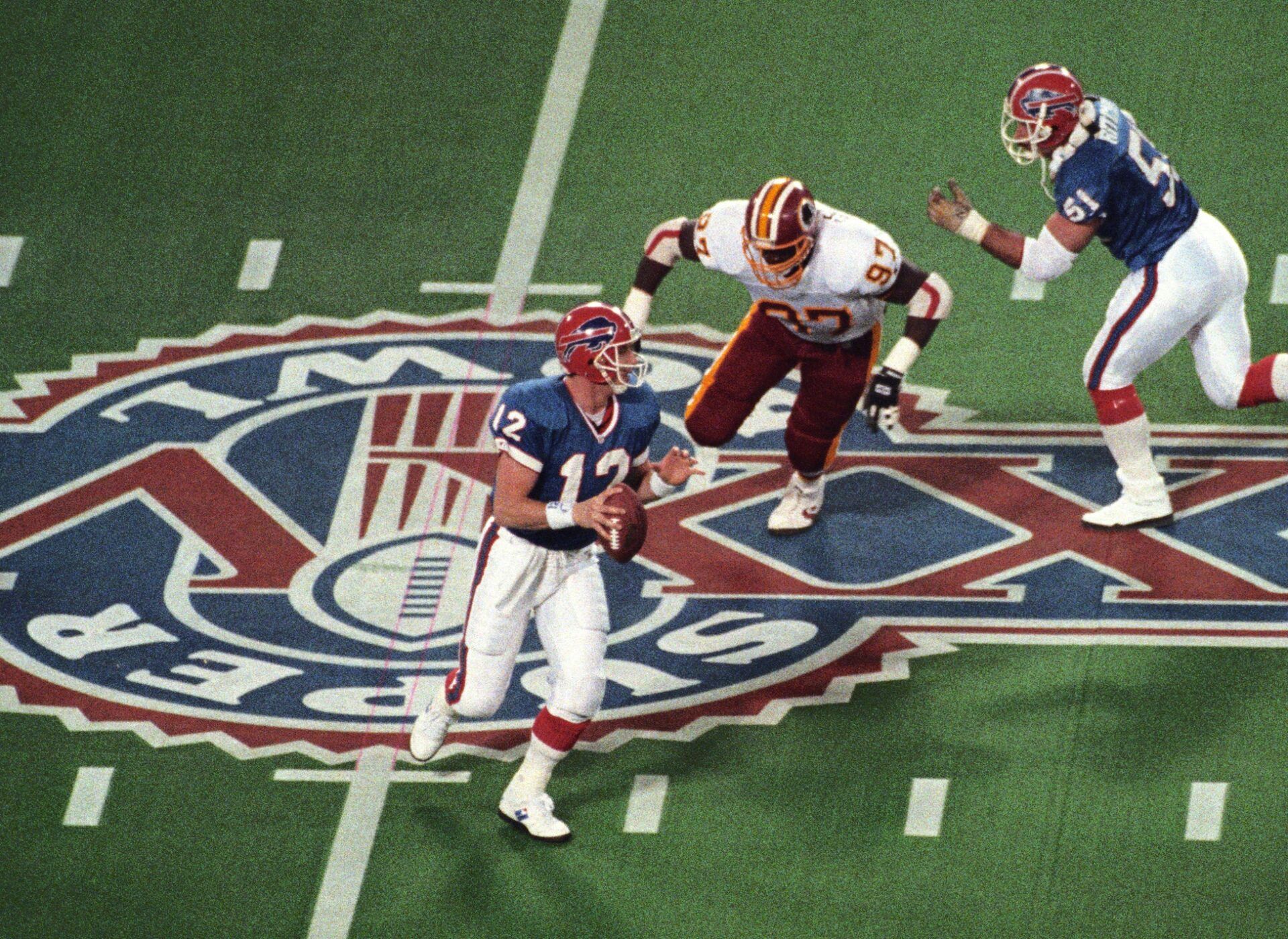 Washington Redskins defensive tackle James Geathers (97) pressures Buffalo Bills quarterback Jim Kelly (12) during Super Bowl XXVI at the Metrodome. The Redskins defeated the Bills 37-24.