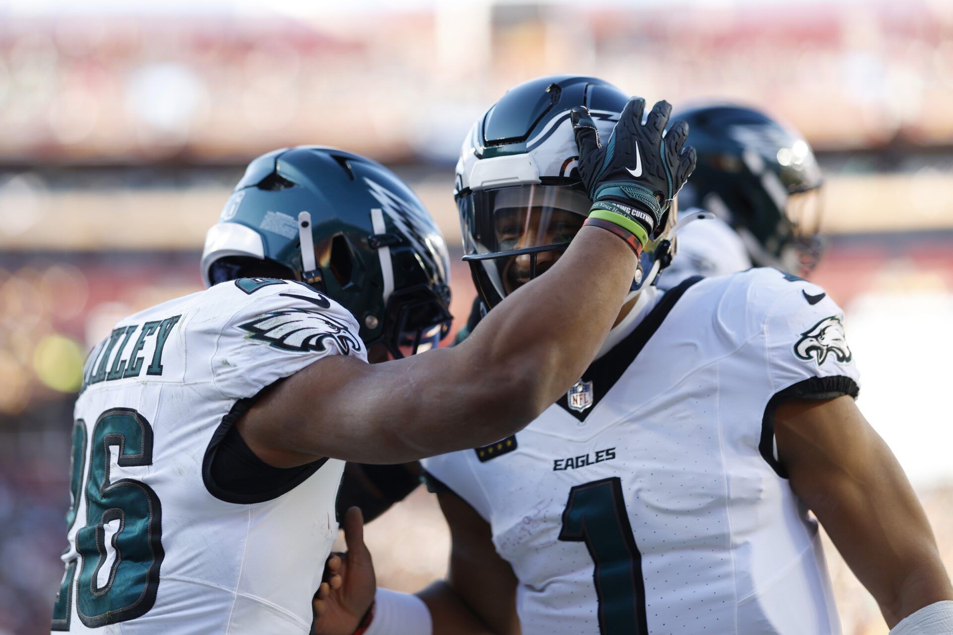 Philadelphia Eagles running back Saquon Barkley (26) celebrates after scoring a touchdown with Eagles quarterback Jalen Hurts (1) against the Washington Commanders during the first quarter at Northwest Stadium.