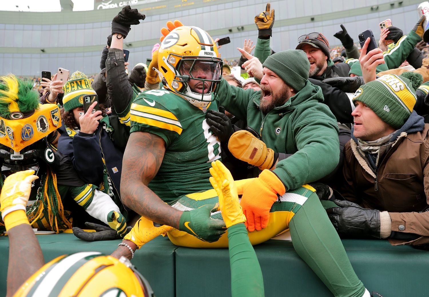 Green Bay Packers running back Josh Jacobs (8) celebrates after scoring a touchdown against the Chicago Bears on Sunday, January 5, 2024 at Lambeau Field. at Lambeau Field.