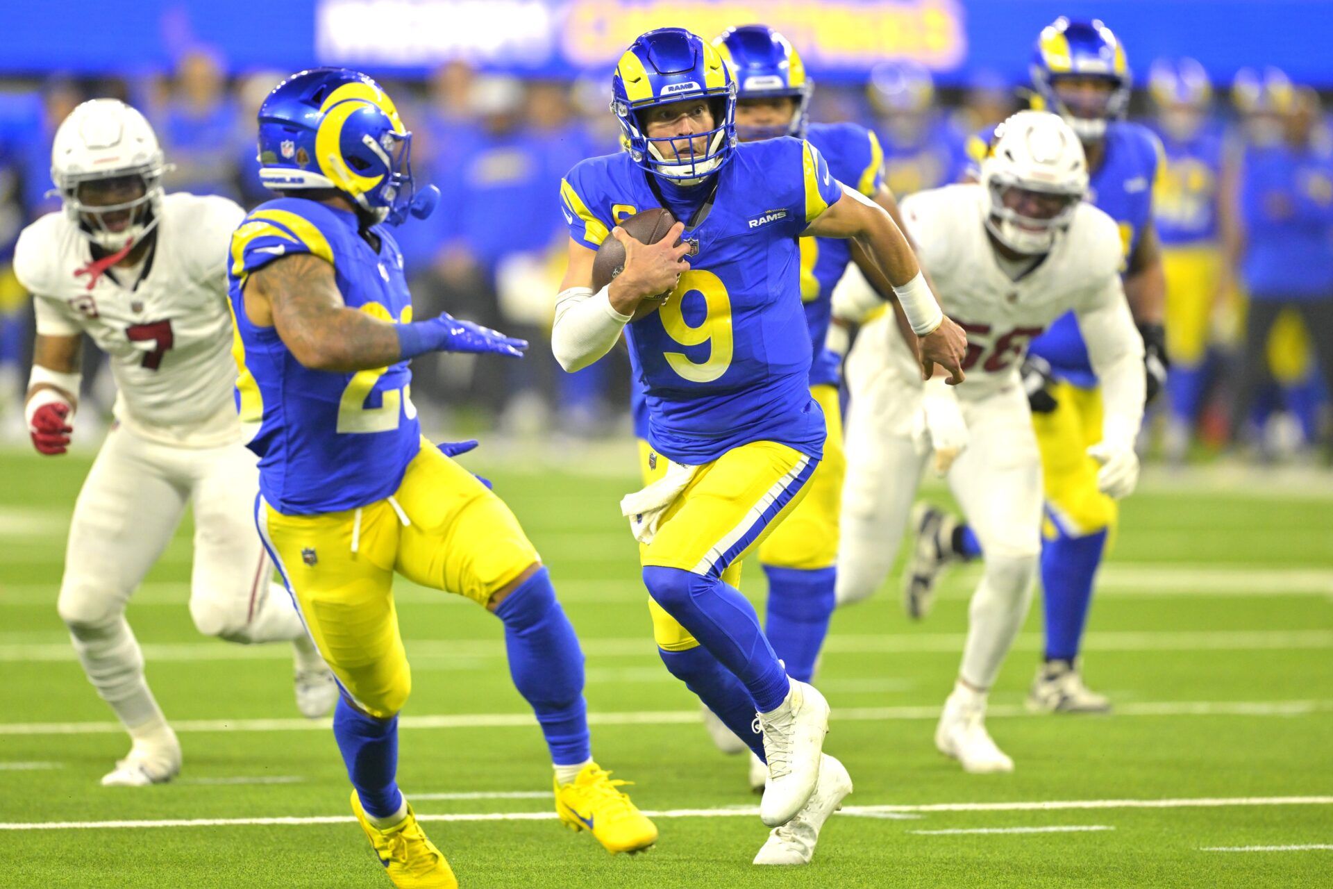 Los Angeles Rams quarterback Matthew Stafford (9) carries the ball to the 5-yard line in the first half against the Arizona Cardinals at SoFi Stadium.