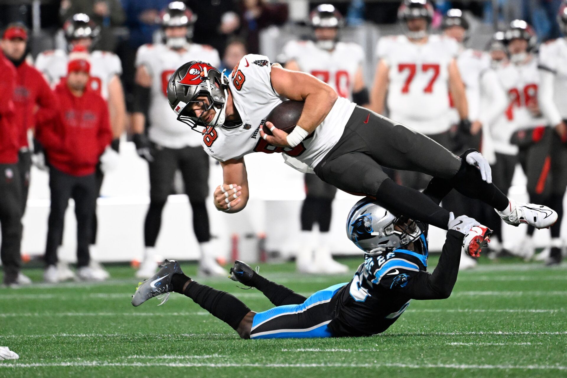 Tampa Bay Buccaneers tight end Cade Otton (88) is tackled by Carolina Panthers cornerback Chau Smith-Wade (26) in overtime at Bank of America Stadium.