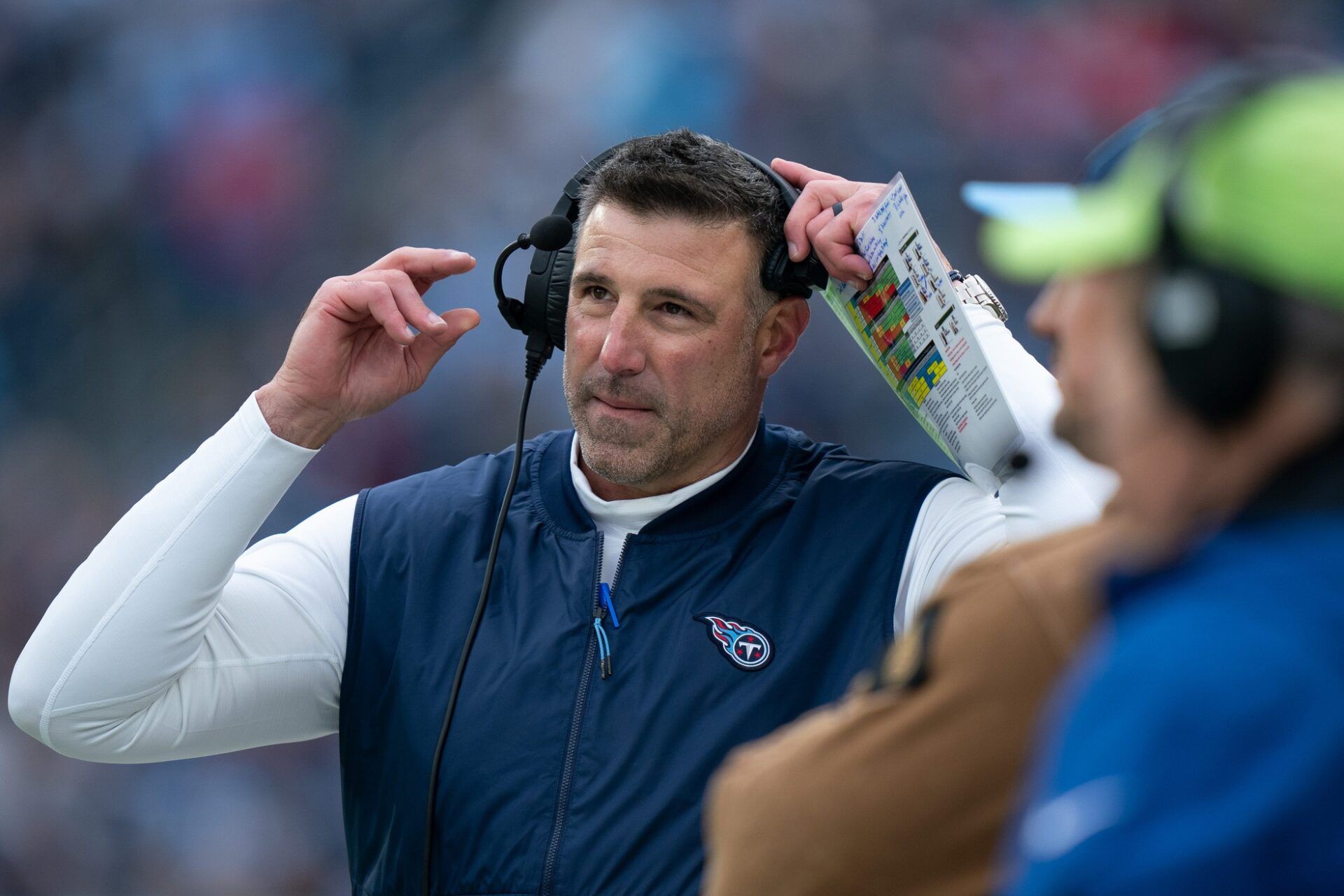 Tennessee Titans head coach Mike Vrabel pulls off his headset during their game against the Carolina Panthers at Nissan Stadium in Nashville, Tenn., Sunday, Nov. 26, 2023.