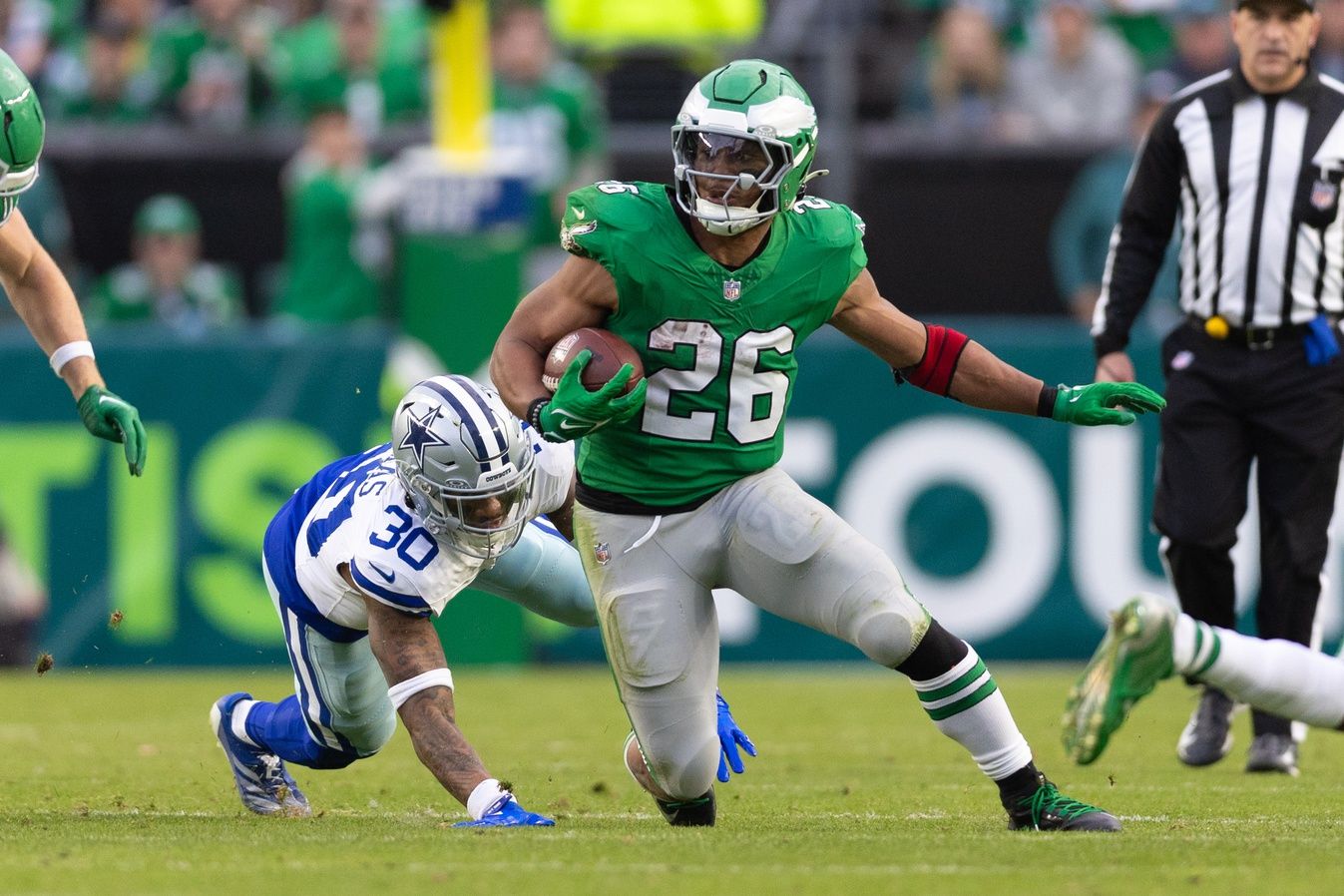 Philadelphia Eagles running back Saquon Barkley (26) runs with the ball past Dallas Cowboys safety Juanyeh Thomas (30) at Lincoln Financial Field.