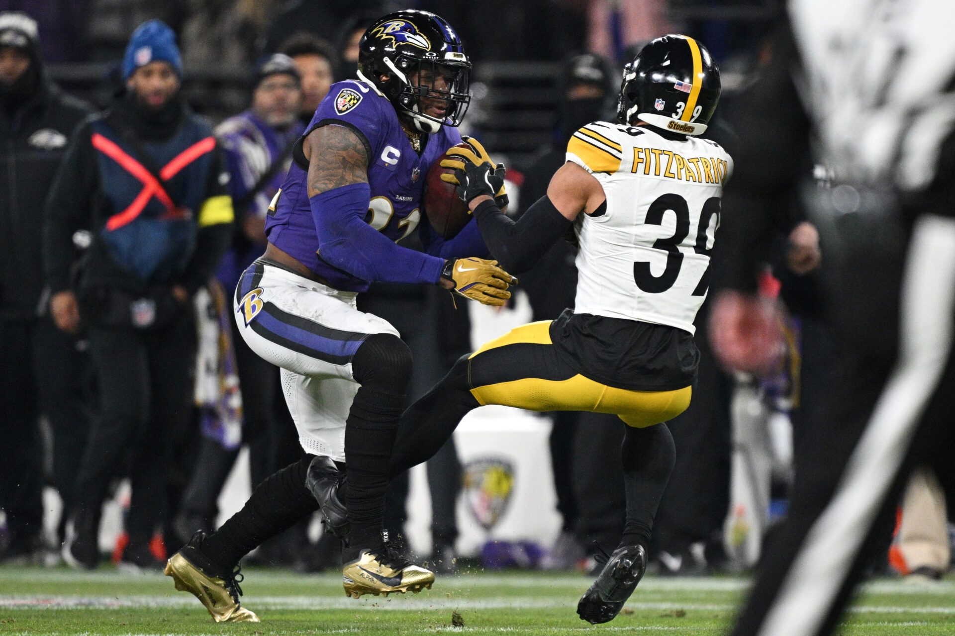 Jan 11, 2025; Baltimore, Maryland, USA; Baltimore Ravens running back Derrick Henry (22) runs against Pittsburgh Steelers safety Minkah Fitzpatrick (39) in the second quarter in an AFC wild card game at M&T Bank Stadium. Mandatory Credit: Tommy Gilligan-Imagn Images