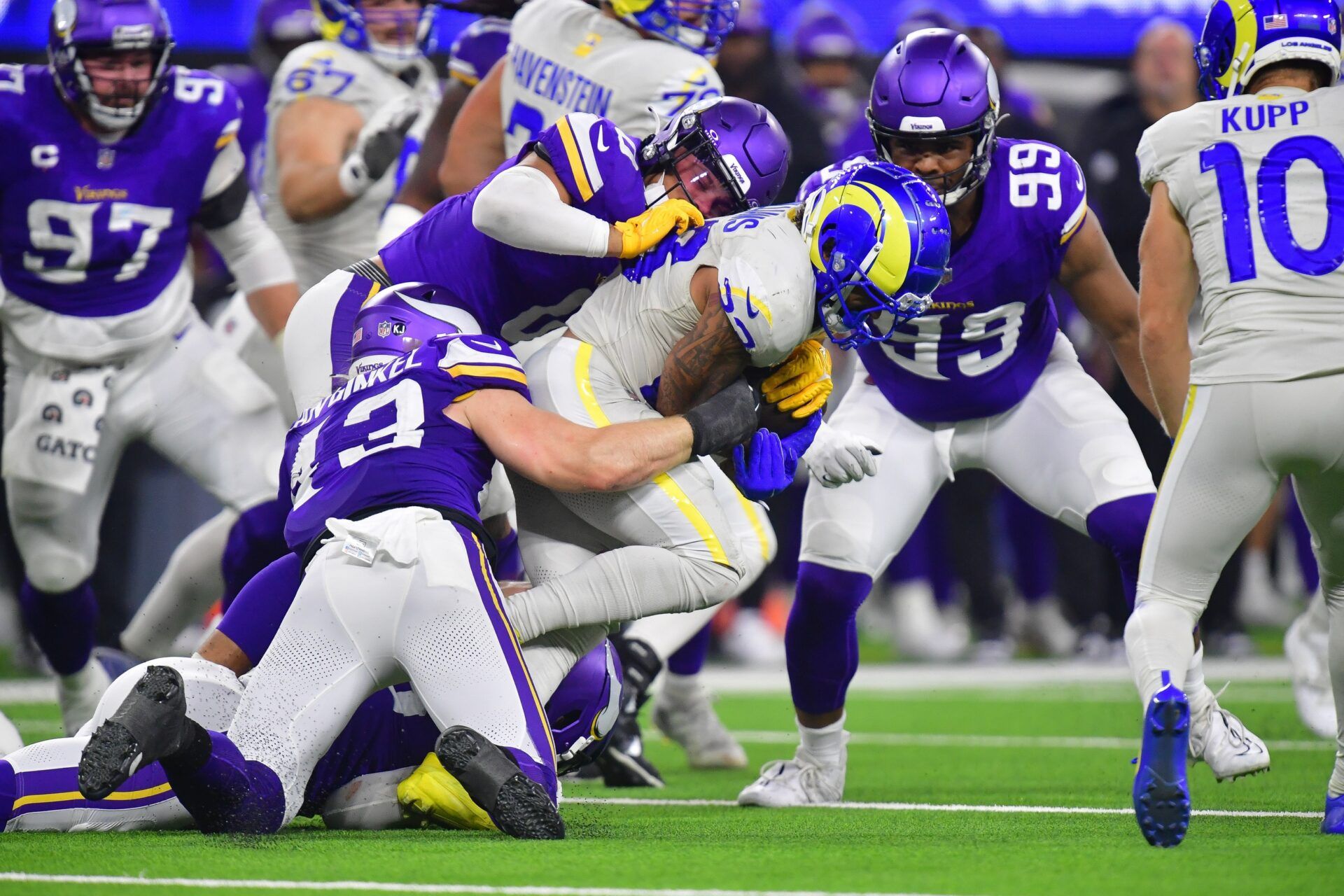 Los Angeles Rams running back Kyren Williams (23) is brought down by Minnesota Vikings linebacker Ivan Pace Jr. (0) and linebacker Andrew Van Ginkel (43) during the first half at SoFi Stadium.