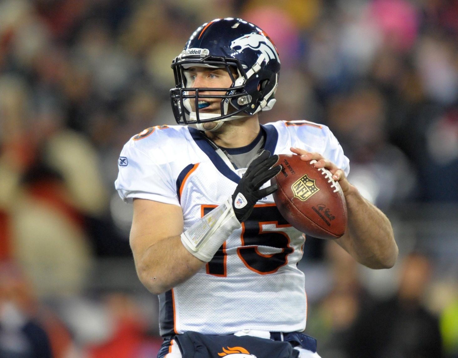 Denver Broncos quarterback Tim Tebow (15) throws a pass in an AFC Divisional playoff game against the New England Patriots at Gillette Stadium.